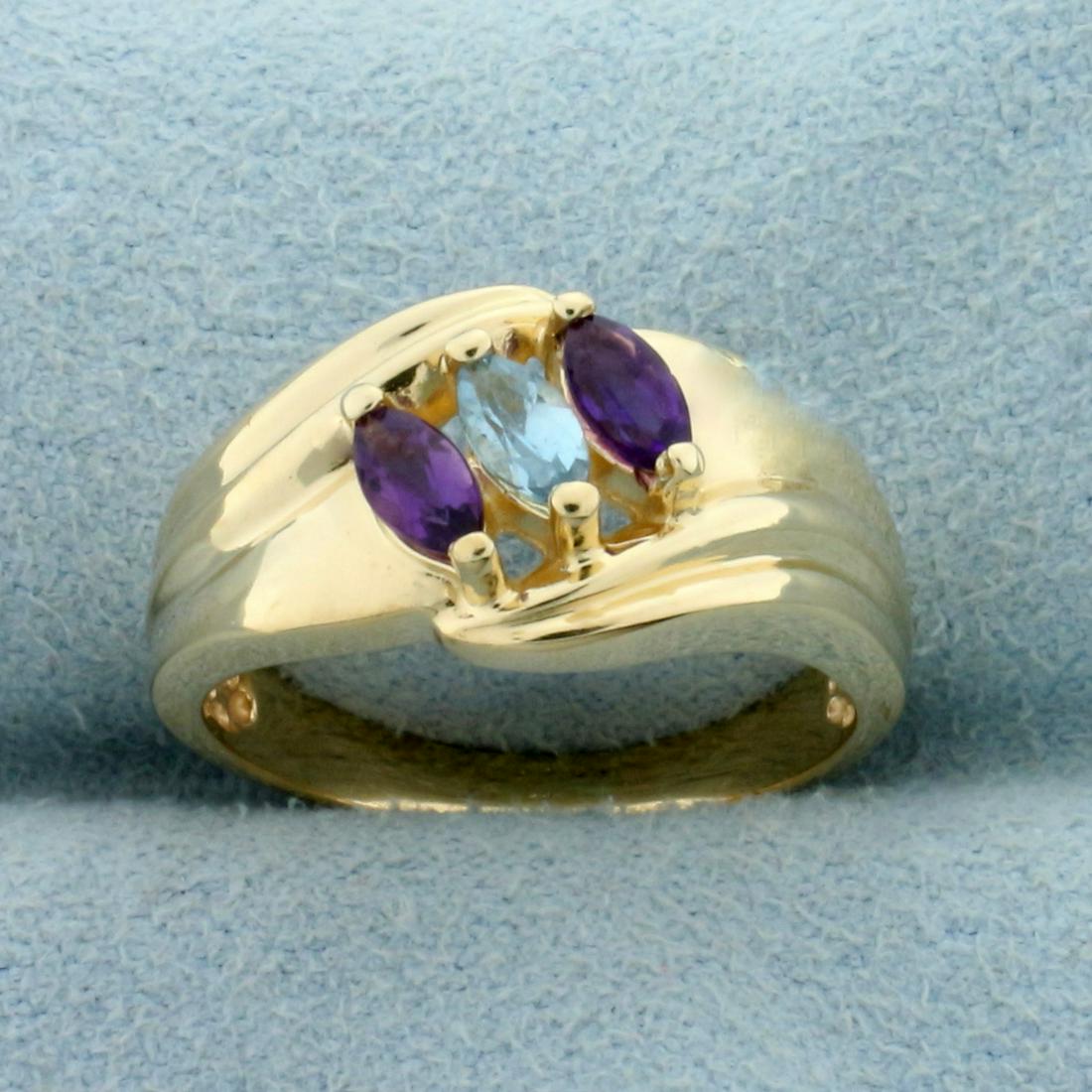 Blue Topaz and Amethyst Ring in 14K Yellow Gold: In 14K Yellow Gold. Contains two high quality natural 4x2mm marquise cut Amethyst gemstones with vibrant purple color and excellent clarity. Also contains one high quality natural 4x2mm marquise cut B