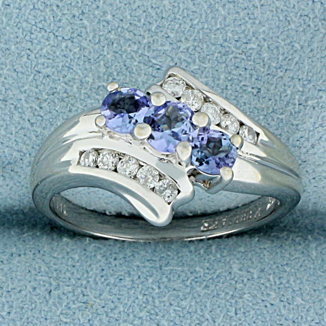 Over 1/2ct TW Synthetic Tanzanite and Diamond Ring in: In 14K White Gold. Contains one 4mm round and two high quality3.5mm round Synthetic Tanzanite gemstones with bright purple color and excellent clarity. Also contains ten high quality .02ct Diamonds, S