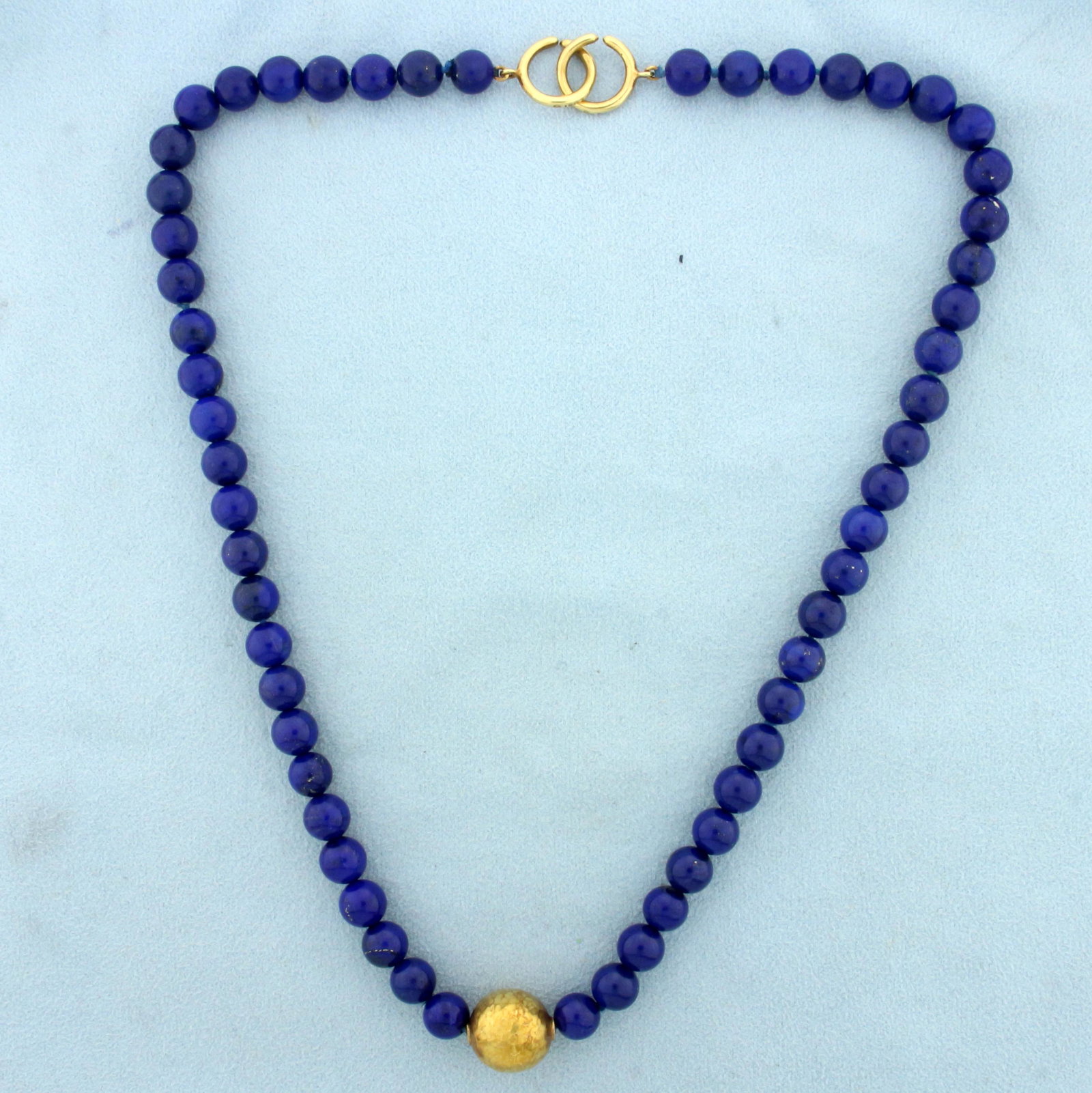 Paloma Picasso Tiffany & Co Lapis Bead Necklace in 18K: In 18K Yellow Gold. Contains one 12.6mm Hammered Gold Bead. Also contains fifty-six 7.15mm Lapis Lazuli Beads with vibrant color and gold flecking. 17 1/2 inches long. Comes with original Tiffany Box.