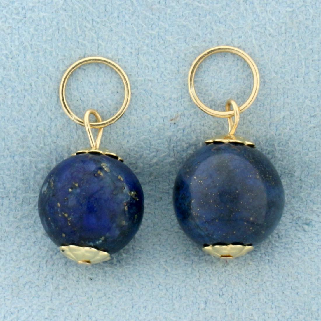 Lapis Lazuli Hoop Earring Enhancers in 14k Yellow Gold: In 14k Yellow Gold. Each contains one high quality natural 10mm Lapis gemstone bead with bright blue color and fleks of gold. 3/4 inch long, 1/2 inch wide. 3.8g.