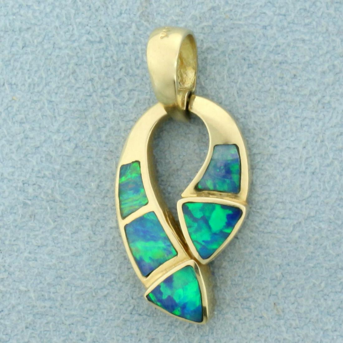 Black Opal Pendant in 14K Yellow Gold: In 14K Yellow Gold. Contains five black opal gemstones ranging from 4 to 4.75mm each, with intense flashes of green and blue. 1 inch long including bale. One opal has slight crazing. 1/2 inch wide. 2.