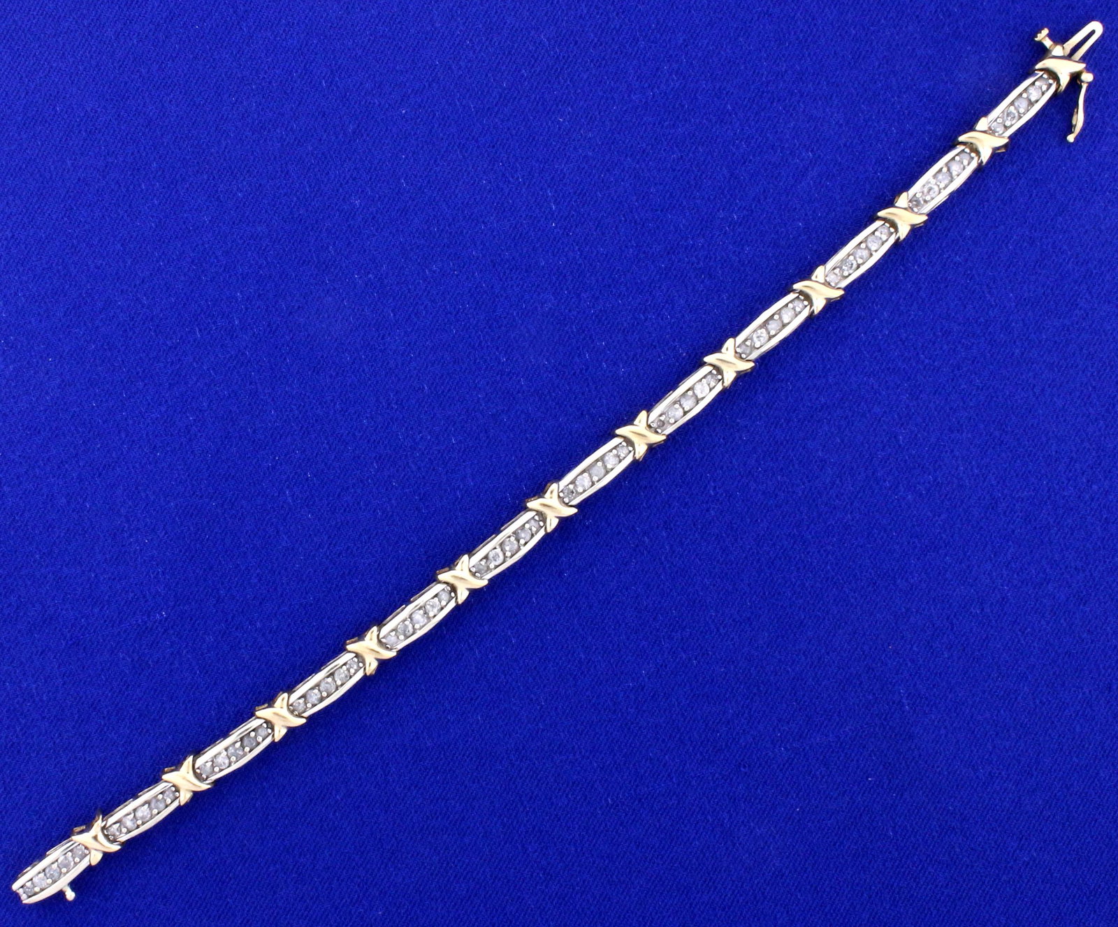 2ct TW Diamond Kisses Style Tennis Bracelet in 10k: In 10k yellow and white gold. Contains 2cts of I clarity/I color diamonds. 7 1/4 inches long with safety clasp. 10.5g.