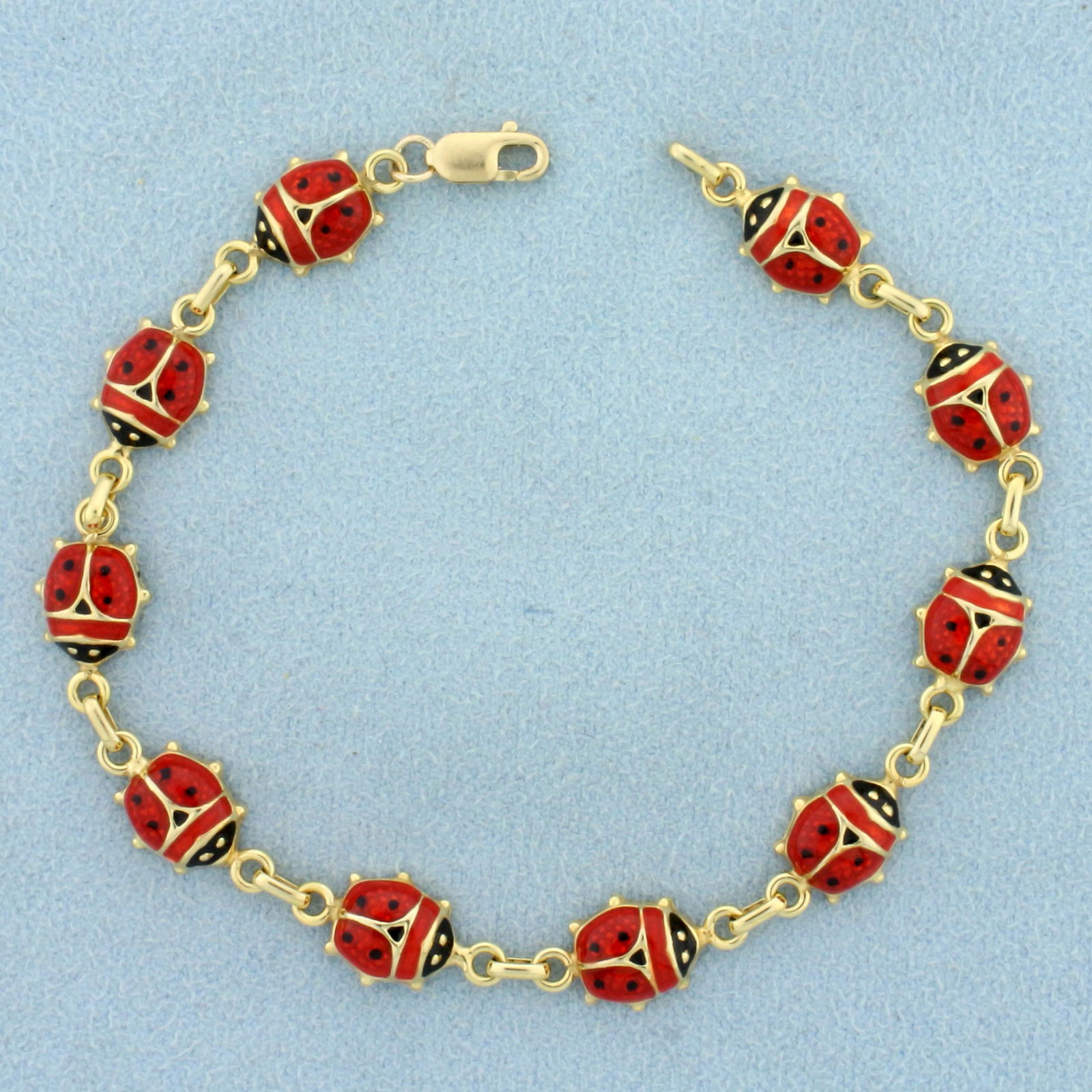 Italian Made Enamel Ladybug Bracelet in 14K Yellow Gold: In 14K Yellow Gold. 6 7/8 inches long, with lobster clasp. 7.8mm wide. 5.8g.