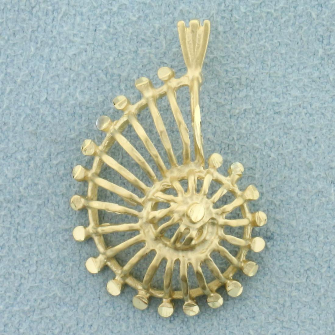 Abstract Spiral Seashell Pendant in 14K Yellow Gold: In 14K Yellow Gold. 1 inch long, 3/4 inch wide. 2.0g.
