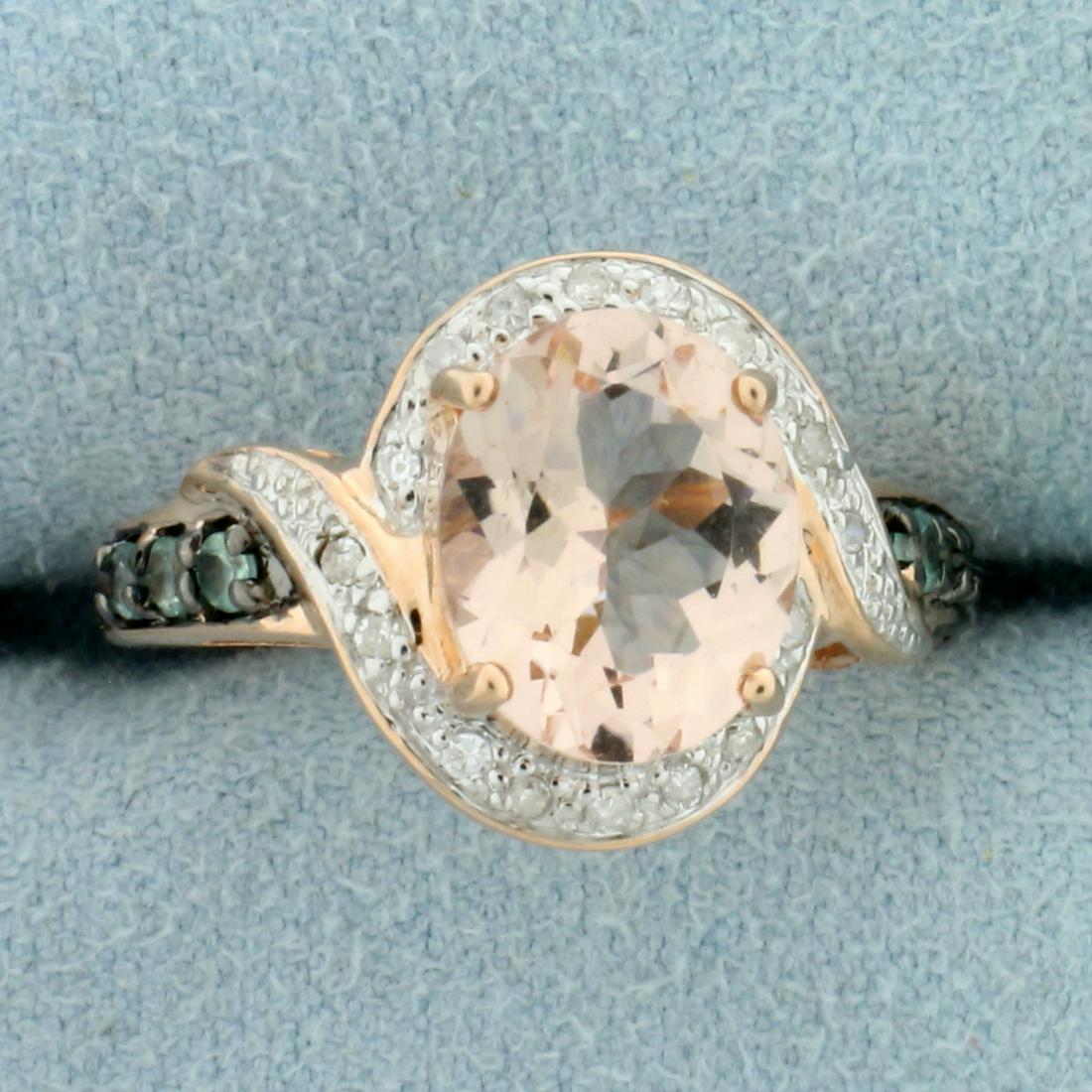 3ct Morganite, Green Topaz, and Diamond Halo Style Ring: In 10K Rose Gold. Contains one high quality 10x8mm oval cut Morganite gemstone with beautiful salmon color and excellent clarity. Also contains and six 2mm Green Topaz gemstones and sixteen 1/2pt Diam