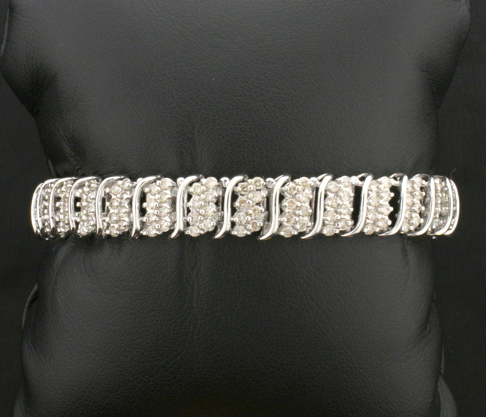 2.3ct TW Diamond Bracelet in 10K White Gold: In 10K White Gold. Contains 232 high quality .01ct round diamonds, SI clarity/K color. 7 inches long, 9.2mm wide. With safety clasp and safety chain. 21.1g.