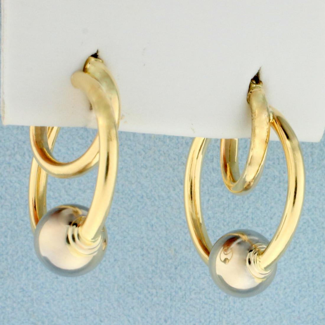 Unique Double Hoop Ball Earrings in 14K Yellow and: In 14K Yellow and White Gold. Hoops in yellow gold, ball in white gold. 1 inch long. 3/4 inch wide. 2.5g