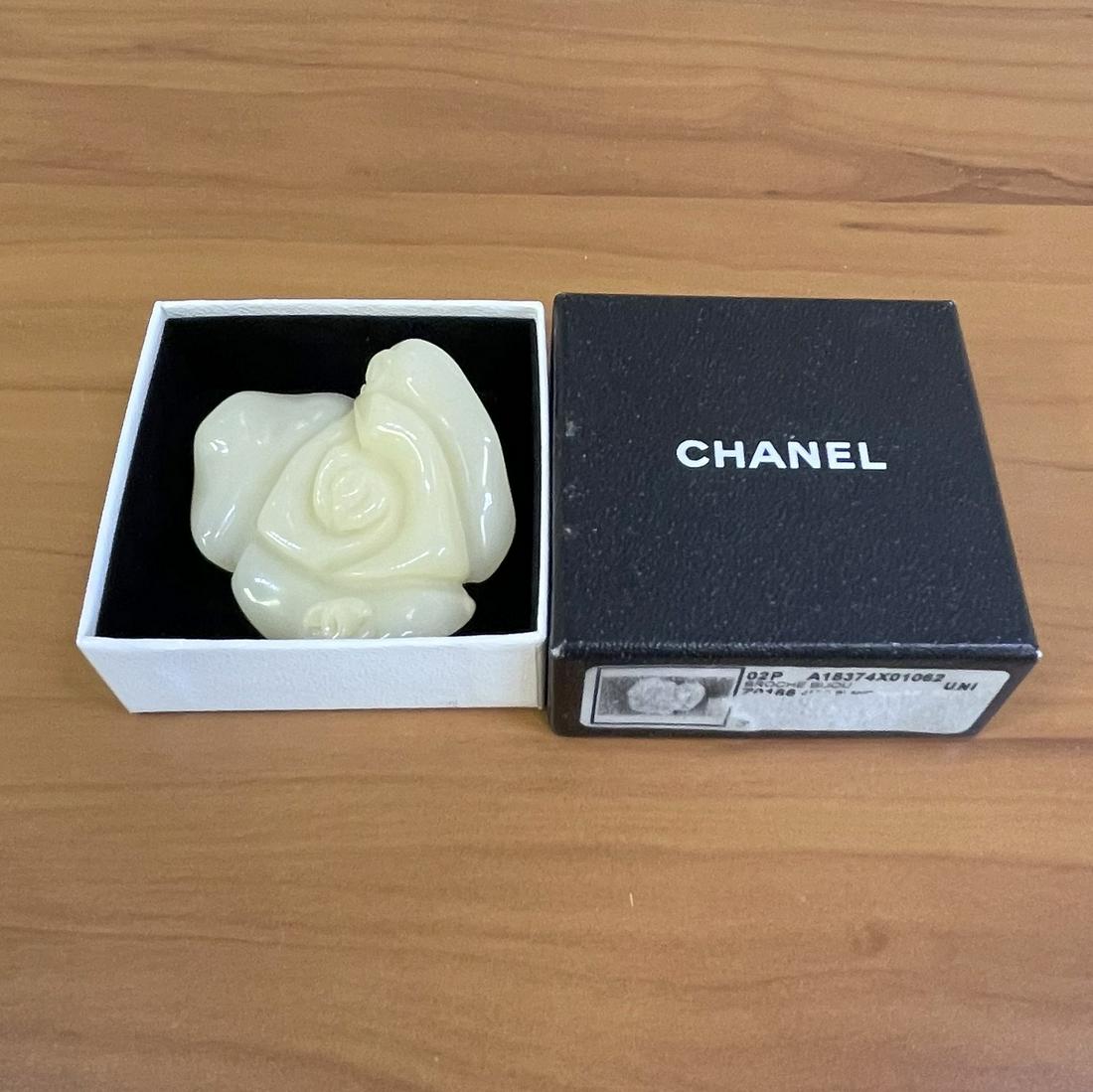 Authentic Chanel Resin Camella Flower Brooch Broche: Guaranteed authentic with original box. Made from white resin. From spring 2002 collection by Karl Lagerfeld. Made in France. Excellent condition. Approx. 2x2 inches. 26.8g