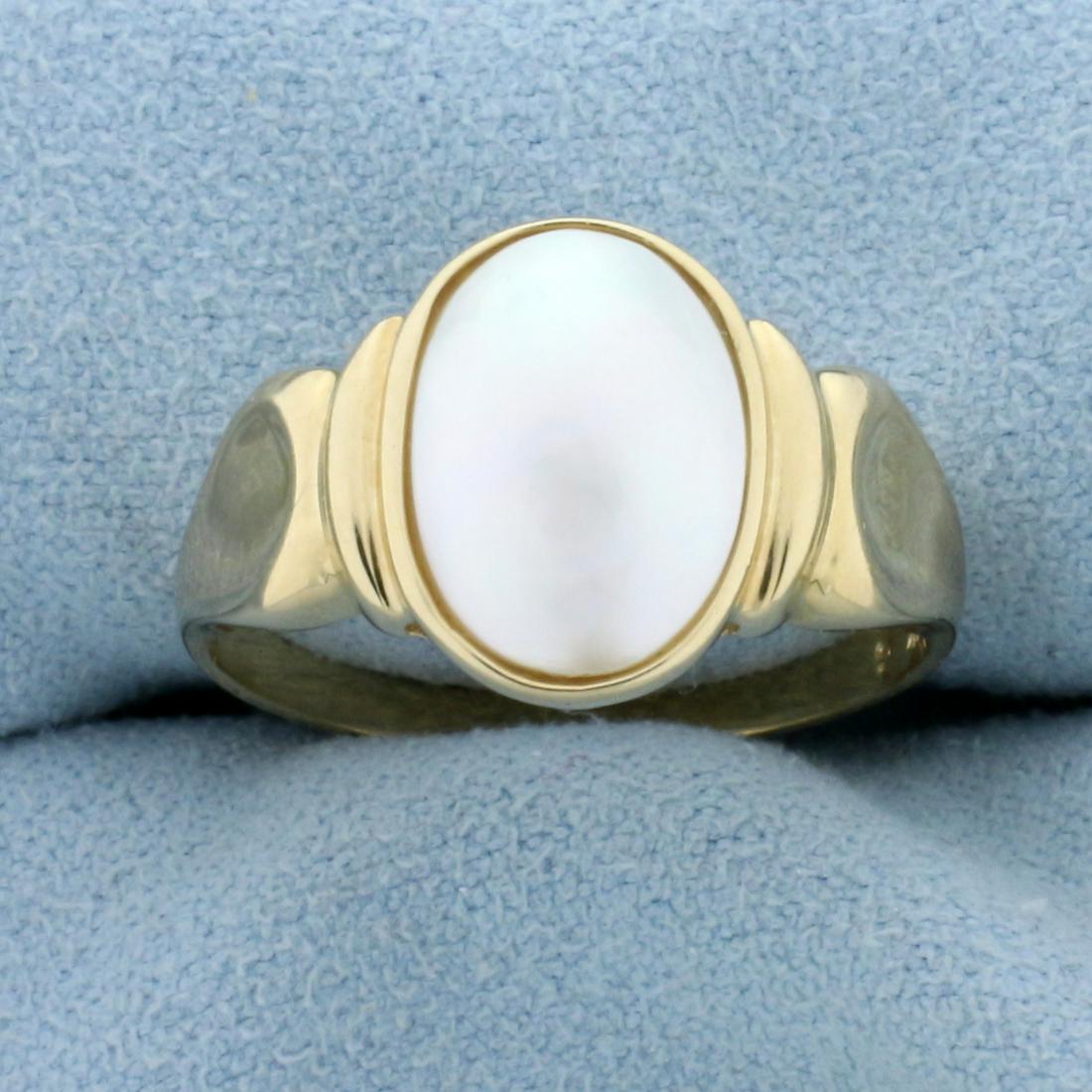 Mabe Pearl Solitaire Ring in 14K Yellow Gold: In 14K Yellow Gold. Contains one high quality 11.6 x 8mm oval Mabe Pearl, with great color and iridescent luster. Size 8 1/2. 3.6g