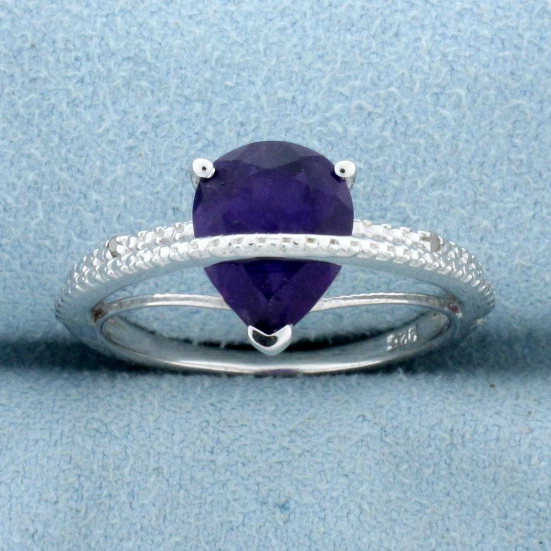 2CT Pear Cut Amethyst & Diamond Ring in Sterling Silver: Pear cut 2.04ct amethyst gemstone ring, accented with .01ctw genuine diamond. Size 8. Set in platinum over sterling silver, 3.3g.