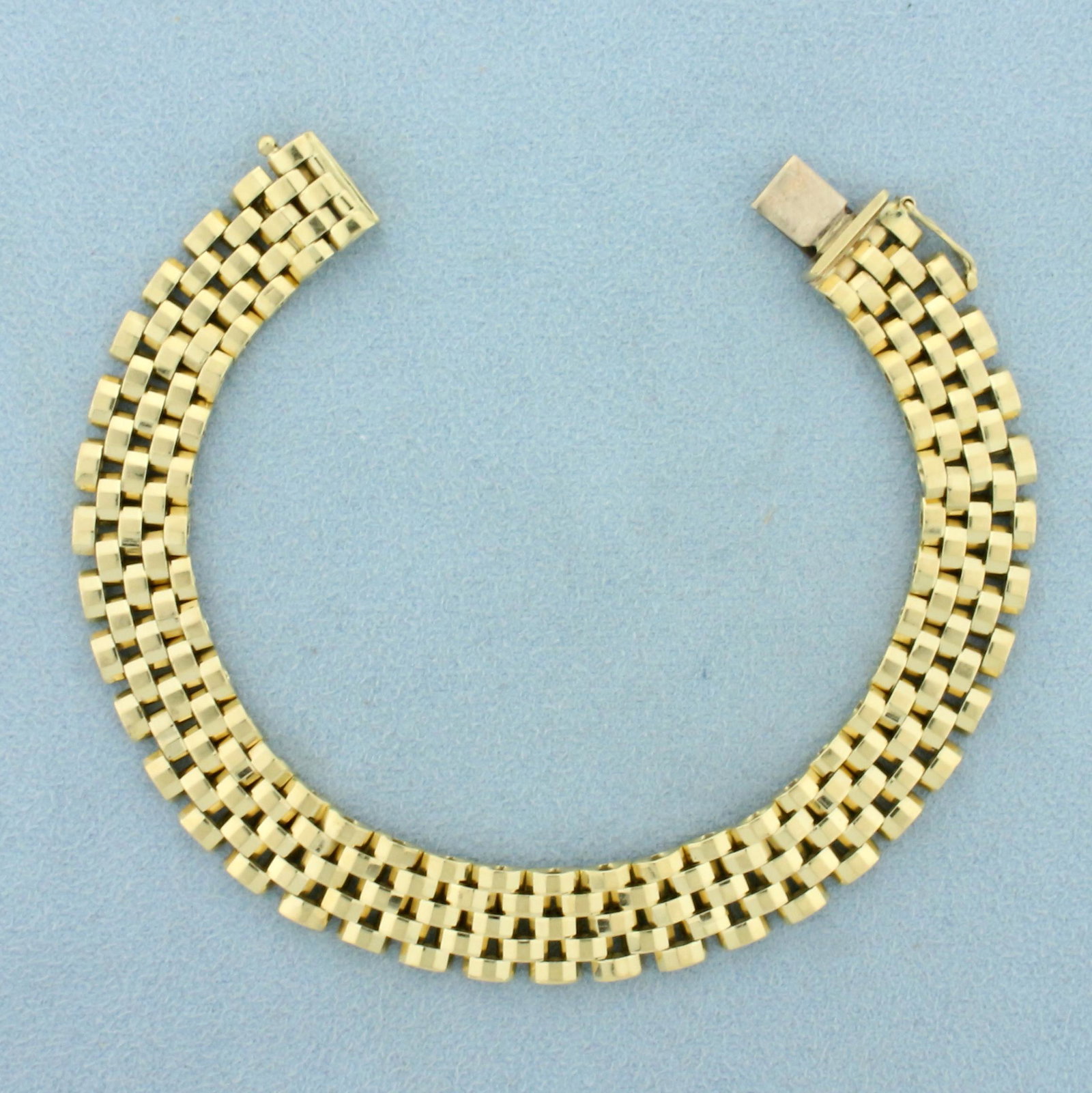 Panther Link Bracelet in 14K Yellow Gold: In 14K Yellow Gold. 7 1/2 inch long. 10.3mm wide. Safety clasp. 19.2g