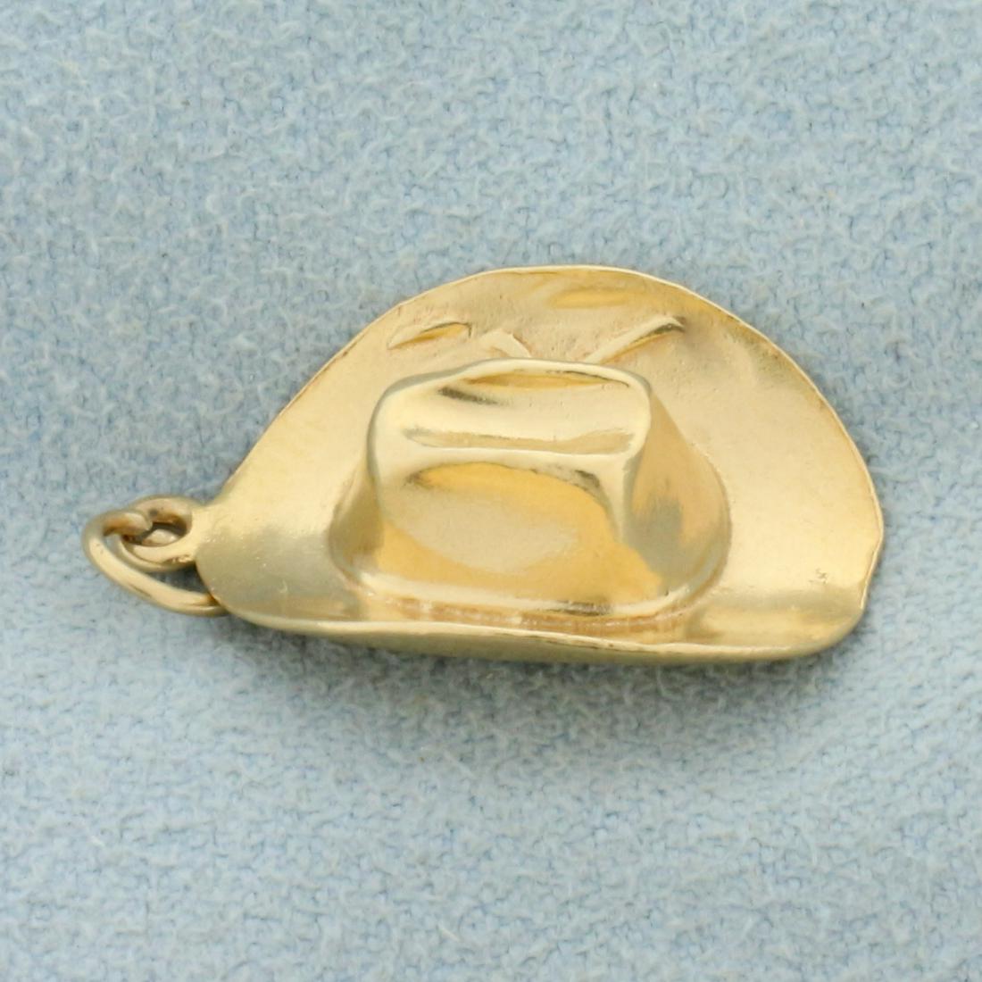 Cowboy Hat Charm or Pendant in 14K Yellow Gold: In 14K Yellow Gold. 1 inches long including jump ring. 1/2 inch wide. 2.8g