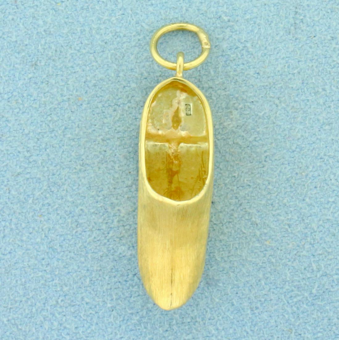 Clog Shoe Charm in 14K Yellow Gold: In 14K Yellow Gold. 1 1/4 inches long including bale. 1/2 inch wide. 2.3g