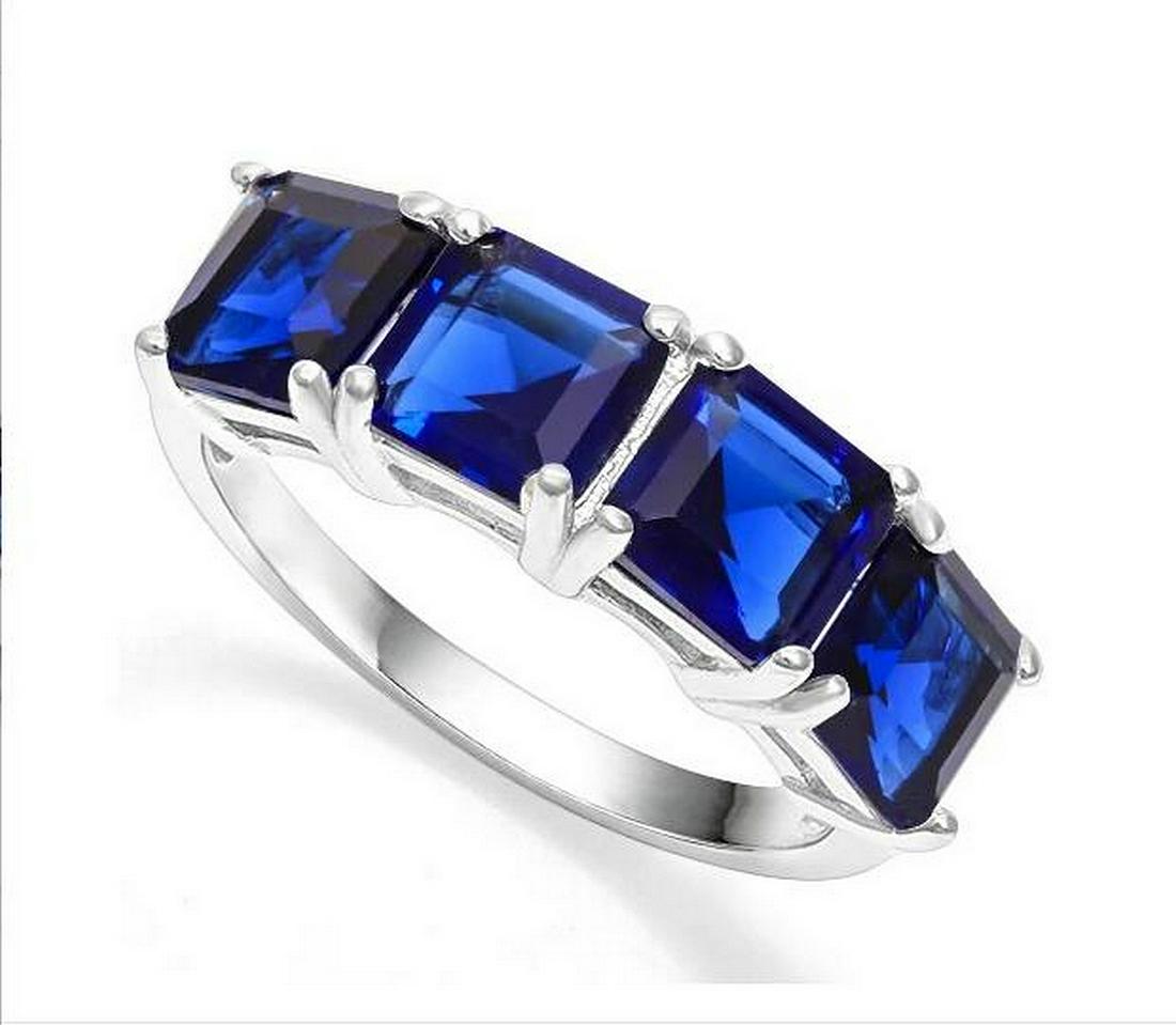 Large Sapphire Line Stack Ring in Sterling Silver: Square step-cut genuine blue sapphire gemstones, lab created, with vivid blue color, are prong set in a stackable ring mounting. Size 6. Set in platinum over sterling silver, 3.3g.