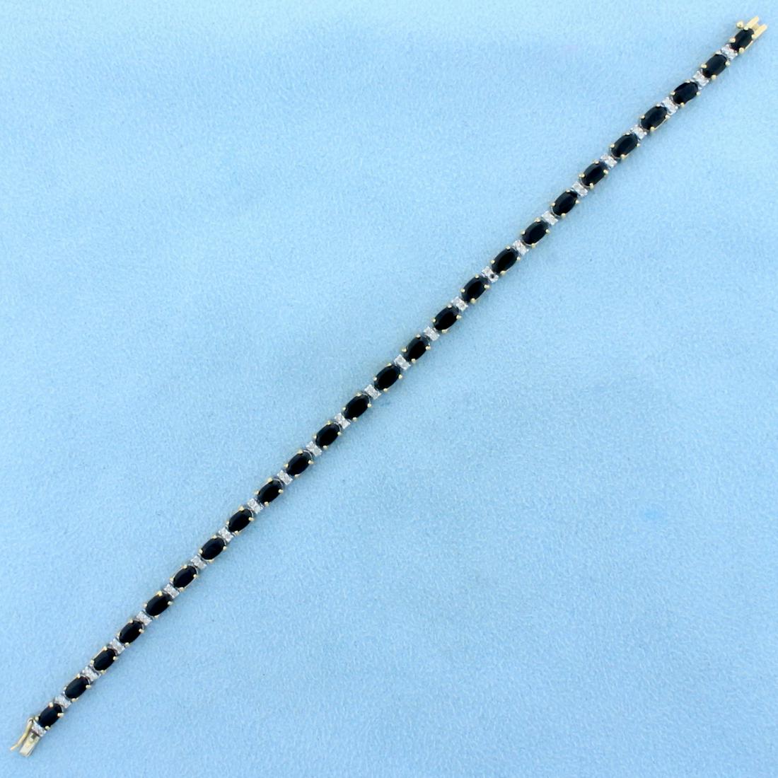 6.5ct TW Onyx and Diamond Tennis Bracelet in 14K Yellow: In 14K Yellow and White Gold. Contains twenty-five high quality 5 x 3mm oval Onyx gemstones. Also contains fifty high quality 1/2pt Diamonds. 7 1/8 inches long, 3mm wide. 8.8g.