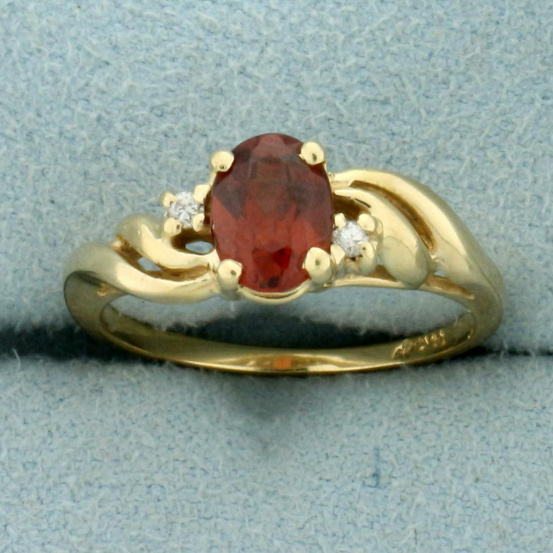 Garnet and Diamond Ring in 14K Yellow Gold: In 14K Yellow Gold. Contains one high quality natural 7x5.2mm oval cut Garnet gemstone, 1ct, with vibrant red color and excellent clarity. Also contains two high quality .01ct Diamonds. Size 6 1/2. 2.