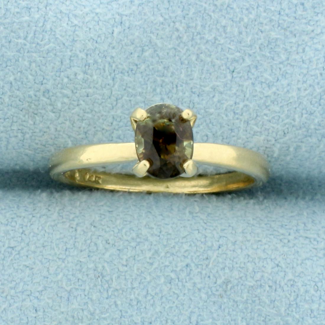 1/2ct Honey Chrysoberyl Solitaire Ring in 14K Yellow: In 14K Yellow Gold. Contains one high quality natural 6 x 4.5mm oval Chrysoberyl gemstone that changes color from greenish brown to honey color with shades of orange depending on lighting source. Size