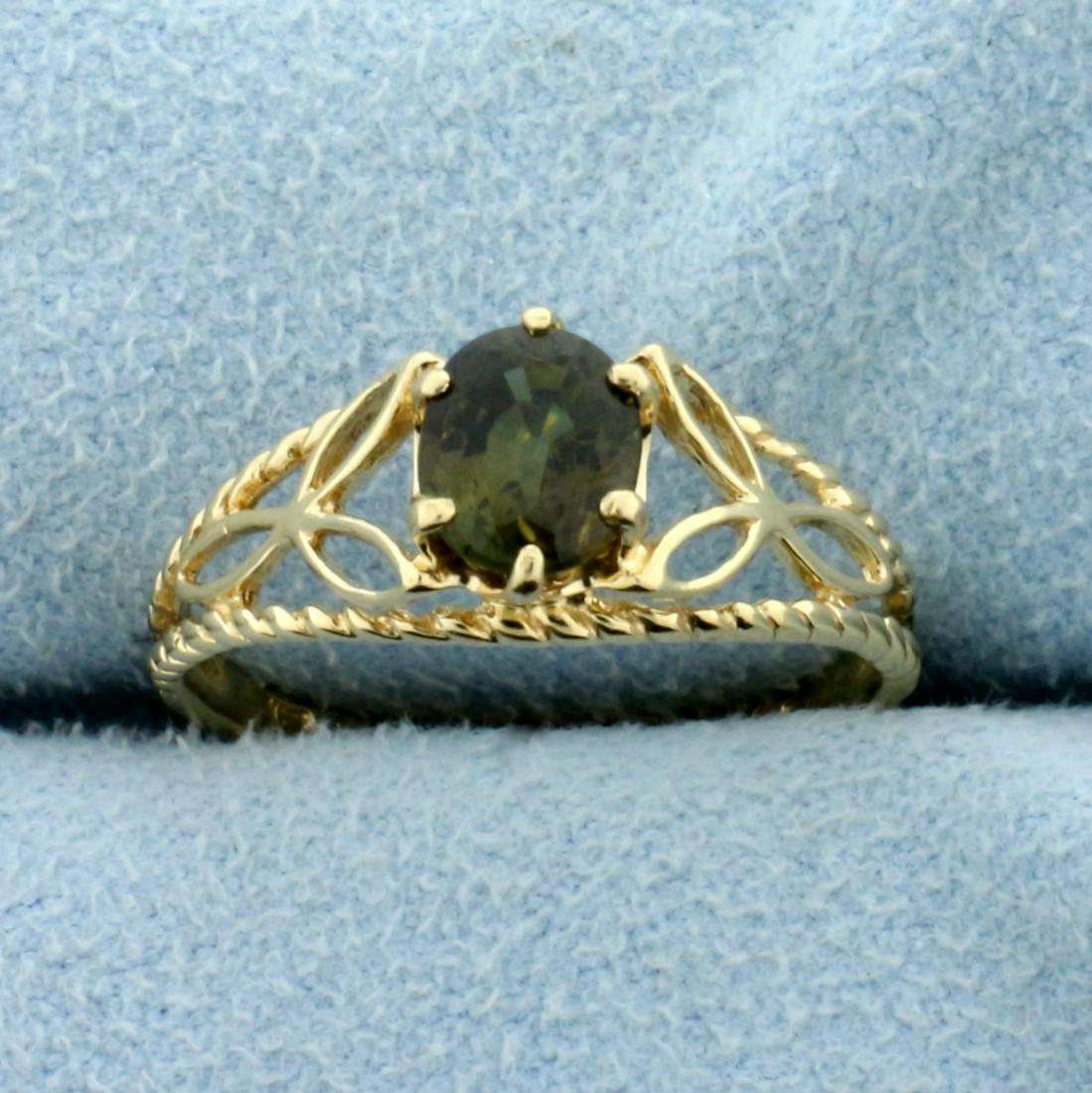 2/3ct Alexandrite Solitaire Ring in 14K Yellow Gold: In 14K Yellow Gold. Contains one high quality natural 6.25 x 5mm oval cut Alexandrite gemstone that changes color from green to gold depending on light source. Size 7 1/4. 1.7g.