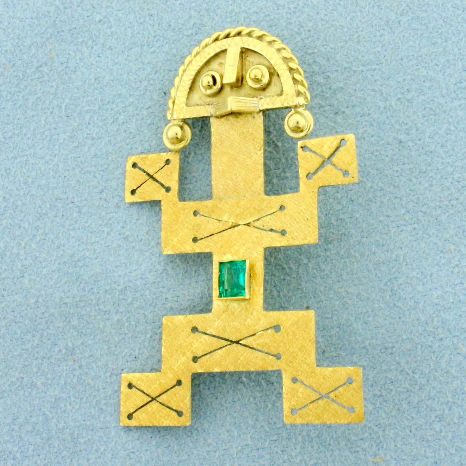 Mayan Aztec Emerald Pin in 22K Yellow Gold: In 22K Yellow Gold. Contains one high quality natural 1/4ct emerald cut Emerald gemstone with intense green color and excellent clarity. 1 3/4 inches long. 1 1/8 inch wide. 6.8g