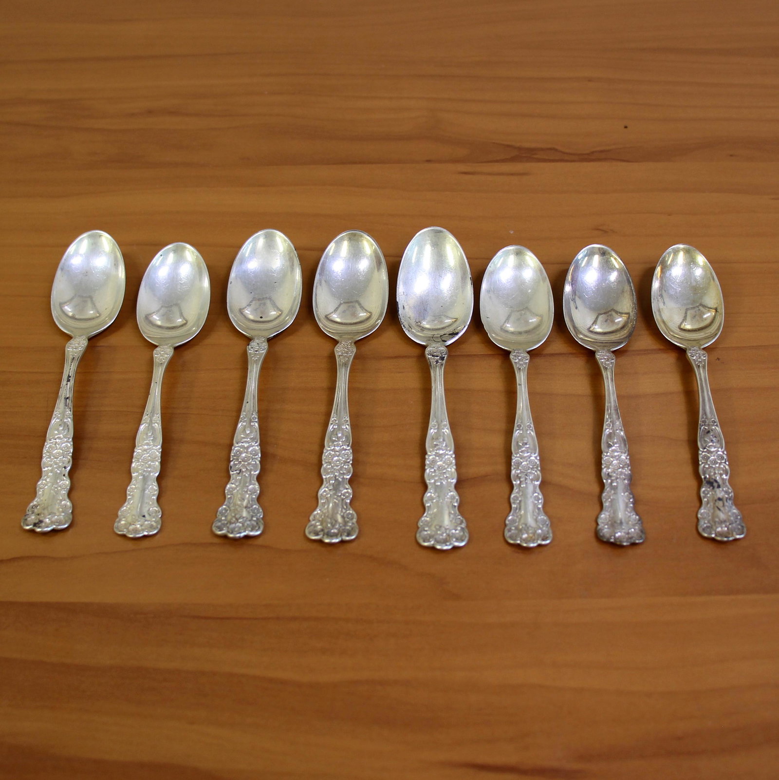 Antique Gorham Buttercup Set of Eight Teaspoons in: In Sterling Silver. Contains four teaspoons @ 5 3/4 inches. Also four teaspoons @ 5 1/2 inches (three are plain and one is monogrammed). 202.2g