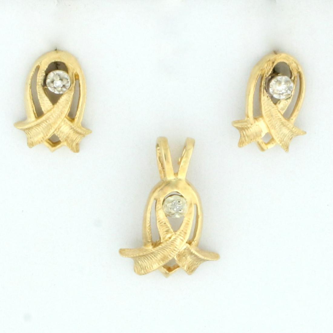 Vintage Ribbon Design Diamond Earrings and Pendant Set: In 14K Yellow Gold. Contains three high quality .01ct Diamonds, SI clarity/I color. Pendant is 1/2 inch long, earrings are 3/8 inches long. Friction backs on earrings. 2g