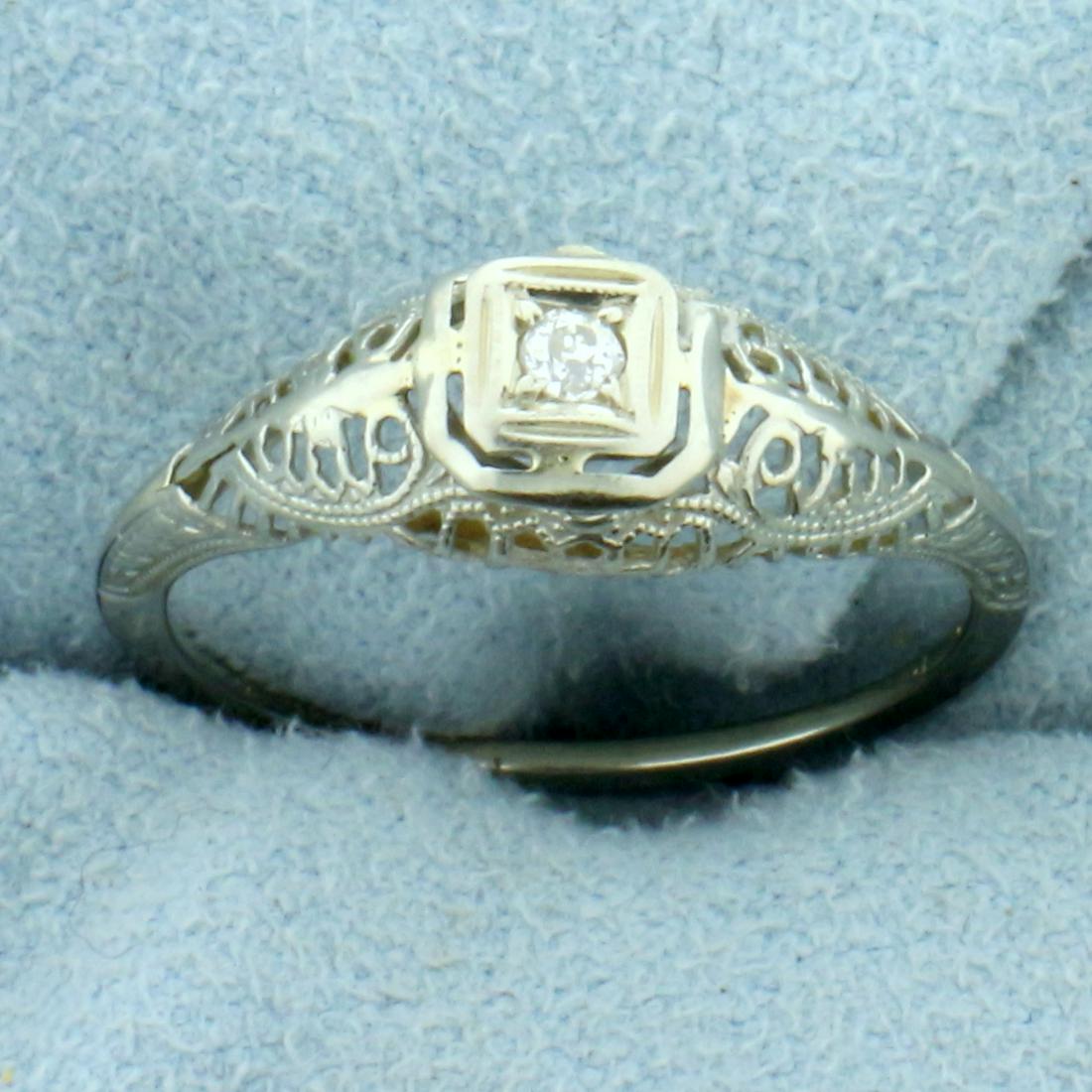 Vintage Filigree Ole European Cut Diamond Solitaire: In 18K White Gold. Contains one high quality 0.03ct Old European cut Diamond, VS clarity/G color. Size 6 1/4. 1.0g.