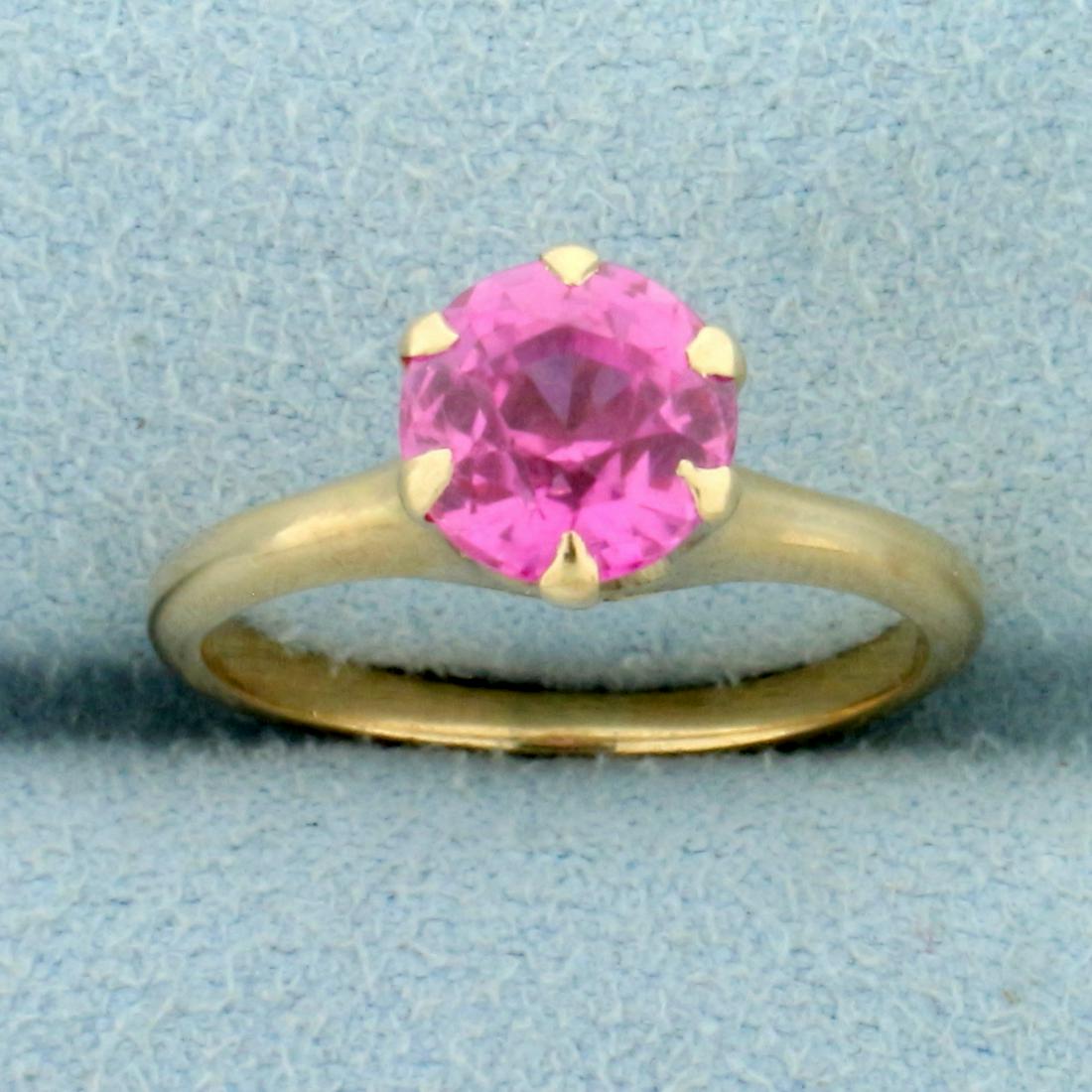 Vintage Lab Pink Sapphire Solitaire Ring in 10K Yellow: In 10K Yellow Gold. Contains one high quality Old European Cut lab 1.25ct Pink Sapphire gemstone with vibrant pink color and excellent clarity. Size 5. 2.6g.