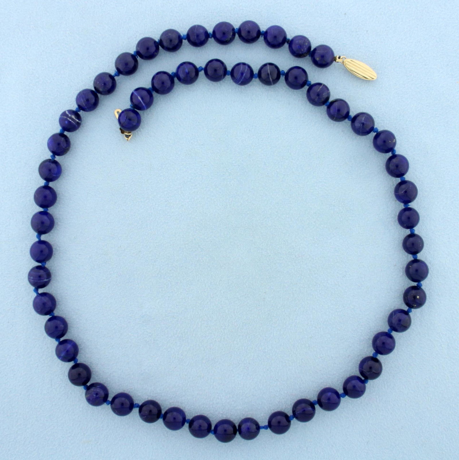 Lapis Lazuli Bead Necklace with 14K Yellow Gold Clasp: 14K Yellow Gold Clasp. 21 inches long. Contains fifty-four high quality natural 8.3mm Lapis Lazuli gemstones with bright blue color. Pairs with bracelet Lot 11398. 43.8g.