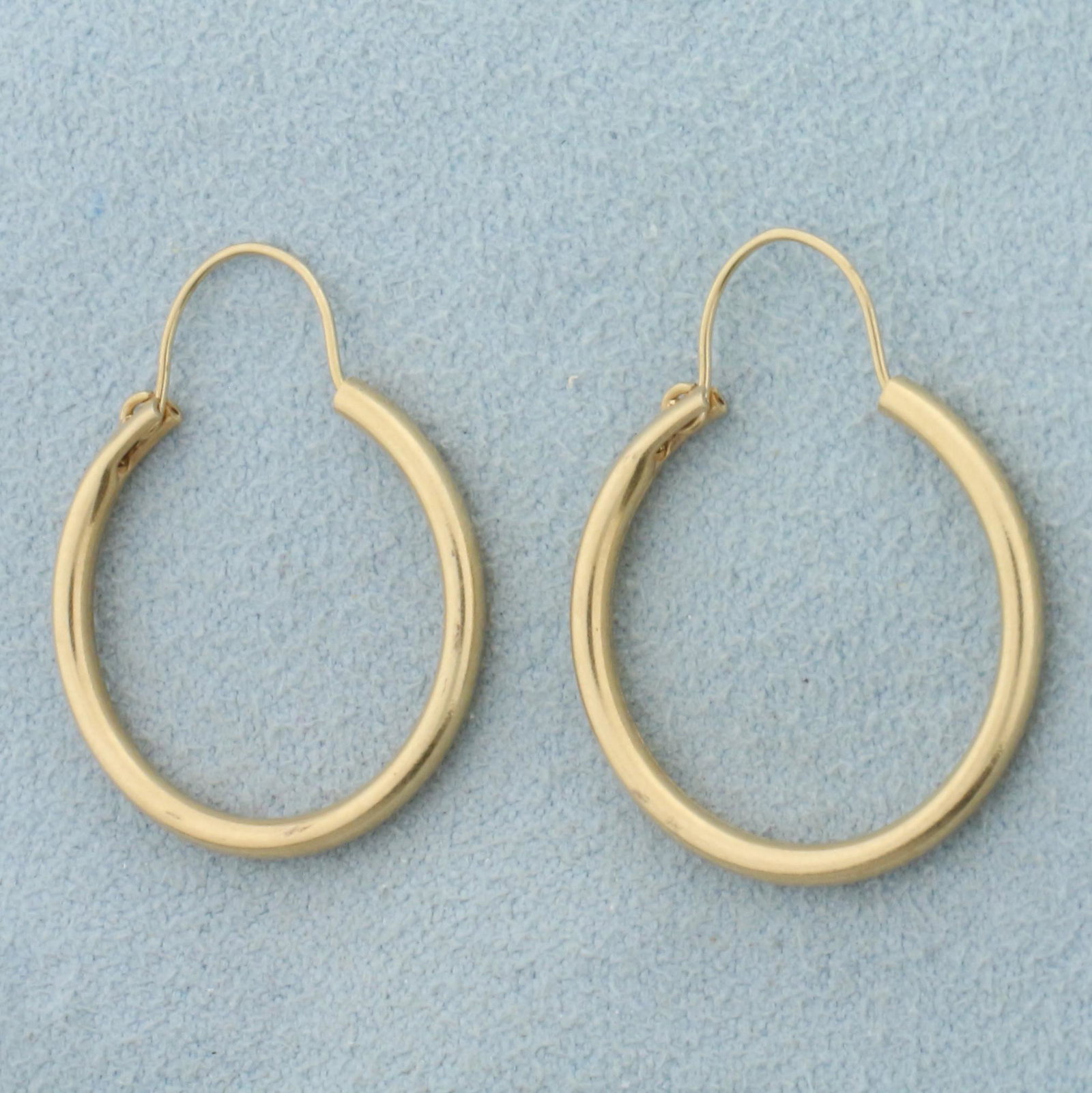Gold Hoop Earrings in 14K Yellow Gold: In 14K Yellow Gold. 1 inch long. 1.8mm wide. 1.6g