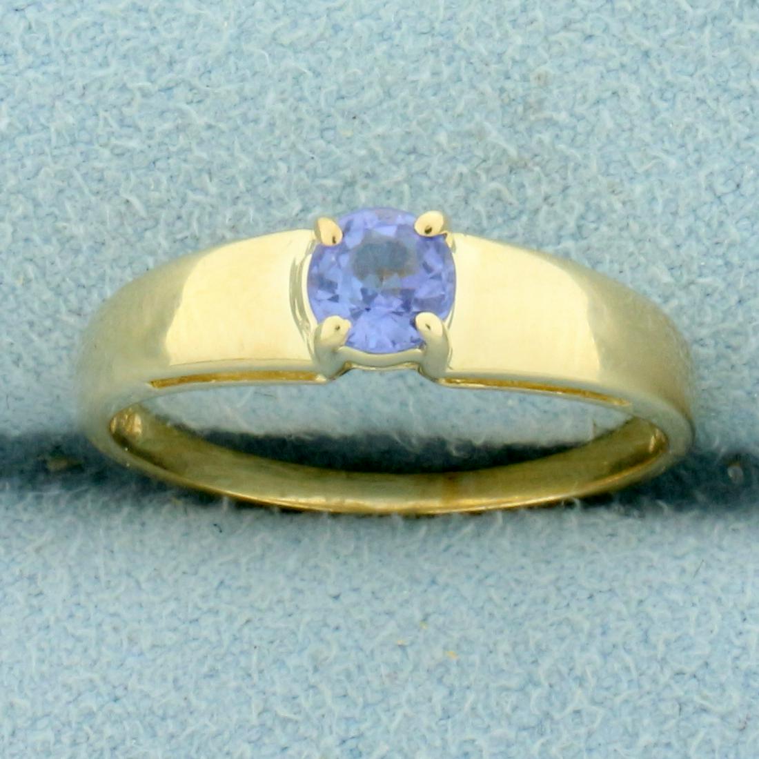Tanzanite Solitaire Ring in 14K Yellow Gold: In 14K Yellow Gold. Contains one high quality 1/3ct Tanzanite gemstone with vibrant purple color and excellent clarity. Size 6 1/2. 2.1g.
