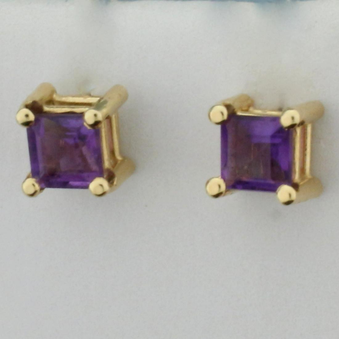 Amethyst Stud Earrings in 14K Yellow Gold: In 14K Yellow Gold. Each earring contains one 4mm princess cut Amethyst gemstone with vibrant purple color and excellent clarity. Basket setting. Friction backs. 1.0g.