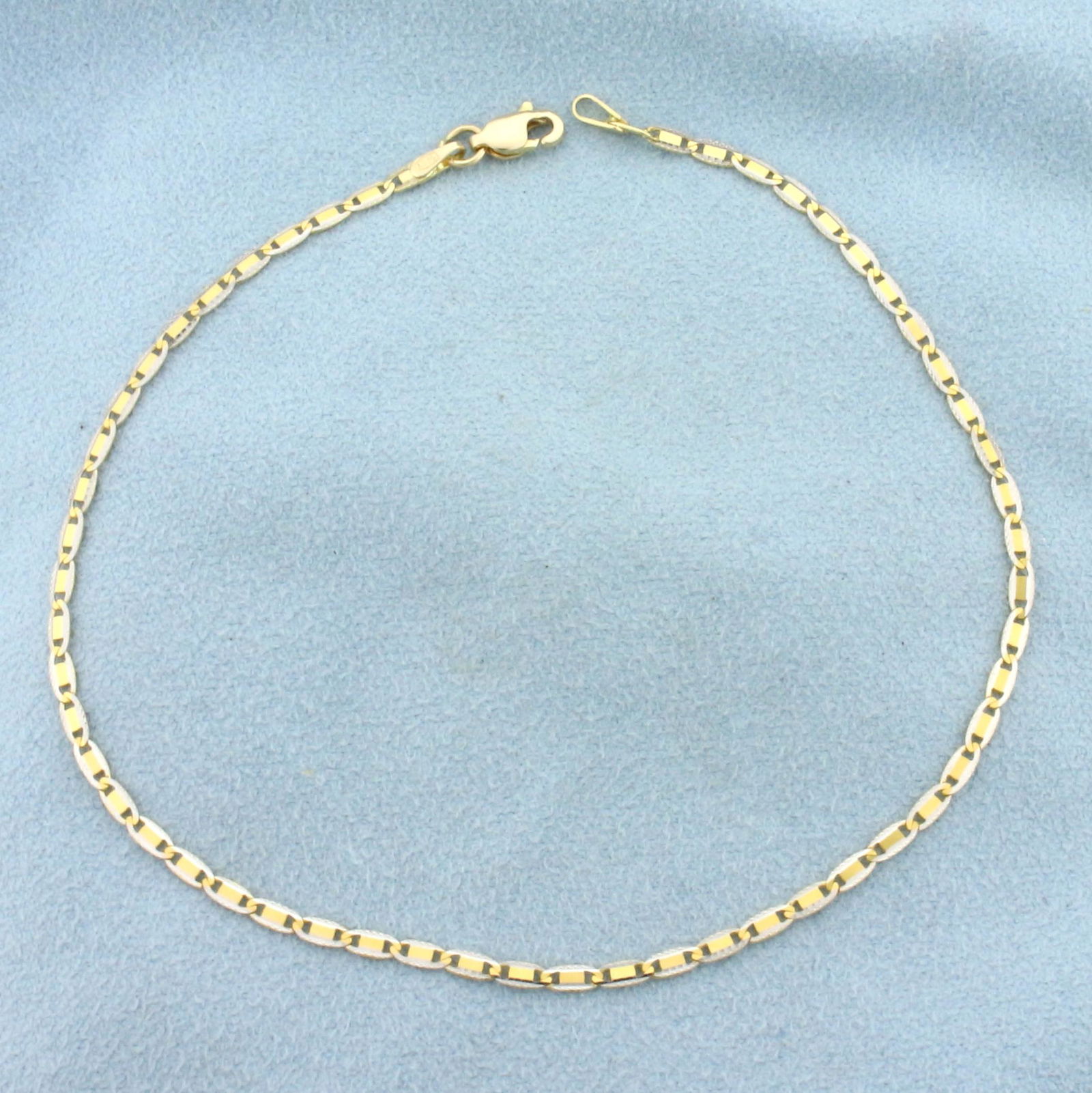 Italian Made 9 Inch Two Tone Anchor Link Anklet in 14K: In 14K Yellow and White Gold. 9 inches long, 2.1mm wide. Lobster clasp. 2.1g.