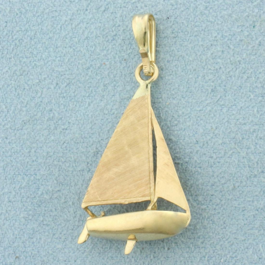 Sail Boat Pendant in 14K Yellow Gold: In 14K Yellow Gold. 1 1/4 inch long including bail. 3/4 inch wide. 2.6g