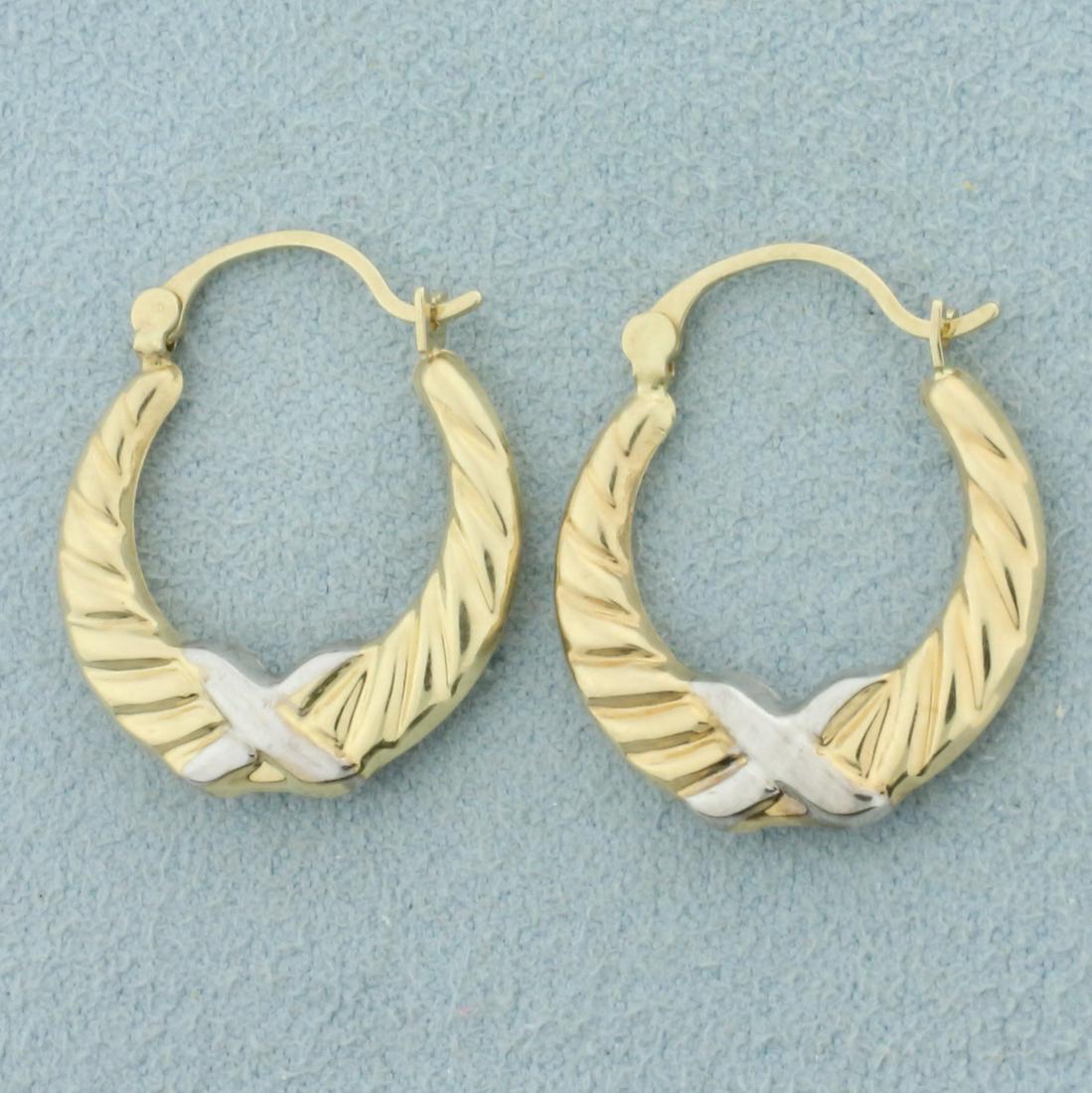 Two Tone Hoop Earrings in 10K Yellow and White Gold: In 10K Yellow and White Gold. Each earring is 3/4 inch long, 2.5mm wide. 0.8g.