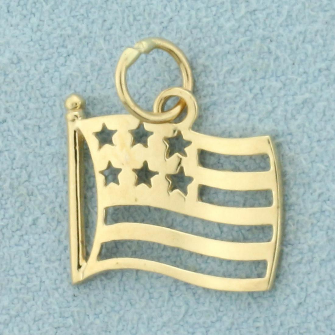 American Flag Charm or Pendant in 14K Yellow Gold: In 14K Yellow Gold. 5/8 inch long/wide. 0.7g.