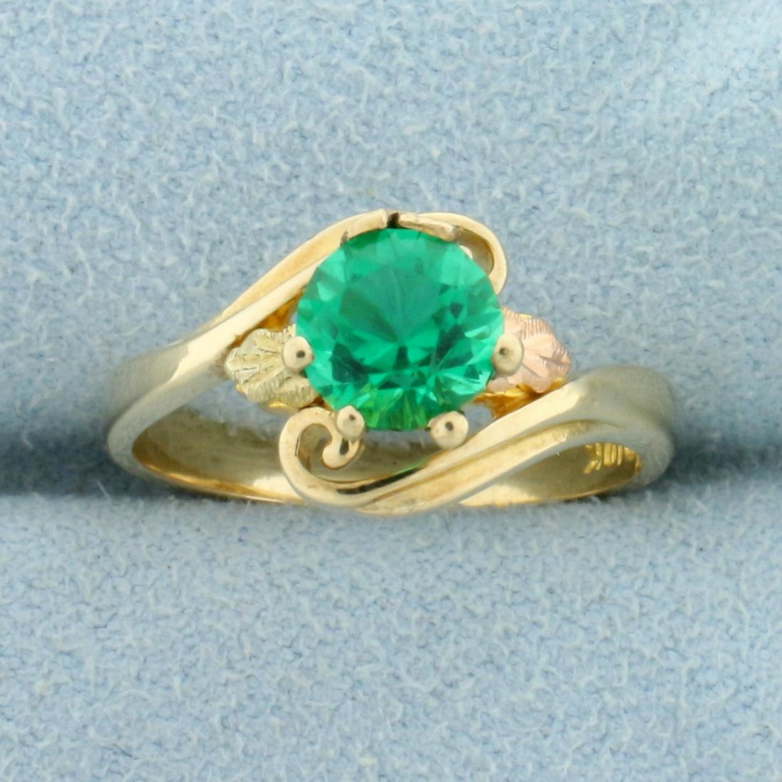 Vintage 1ct Synthetic Emerald Solitaire Bypass Style: In 10K Yellow Gold. Contains a 6.5mm Synthetic Emerald Gemstone with intense green color and excellent clarity. Size 6 1/2. 3.1g