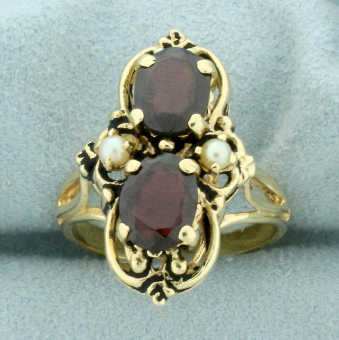Vintage Garnet and Pearl Ring in 14K Yellow Gold: In 14K Yellow Gold. Contains two high quality natural 8 x 6mm oval cut Garnet gemstones with deep red color and excellent clarity. Also contains two high quality 2.5mm Seed Pearls. Size 7 1/4. 6.3g.