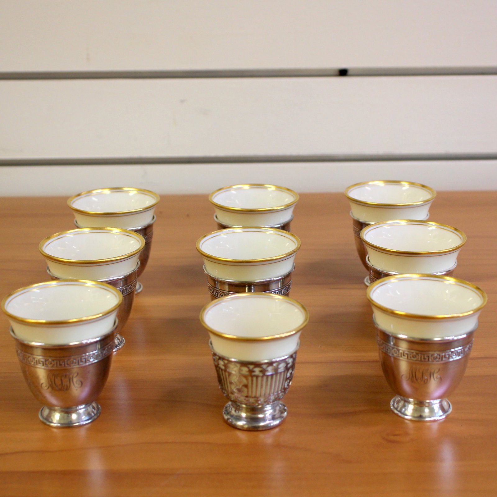Lenox Nine Piece Demitasse Teacup Set in Sterling: In Sterling Silver and Porcelain. 9 Piece teacup set. Lenox china decorated with 24k gold. 1 inch width. 2 1/2 inch height. Monogrammed as shown. 569.0g