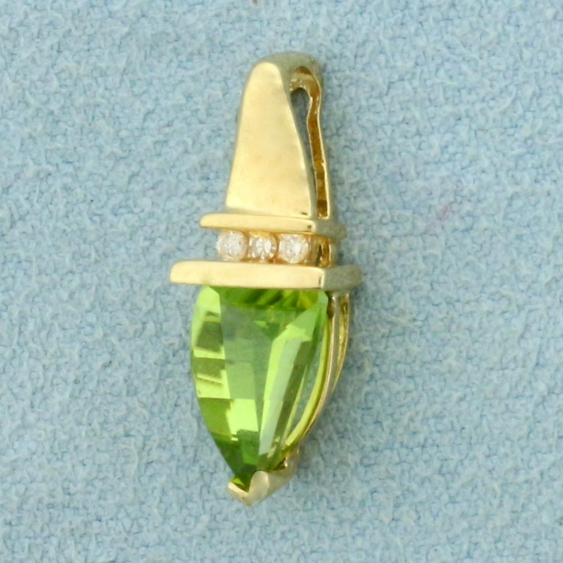 Peridot and Diamond Pendant in 10K Yellow Gold: In 10K Yellow Gold. Contains one high quality natural 8mm unique triangle cut Peridot gemstone with vibrant green color and excellent clarity. Also contains three high quality .01ct Diamonds. 3/4 inch
