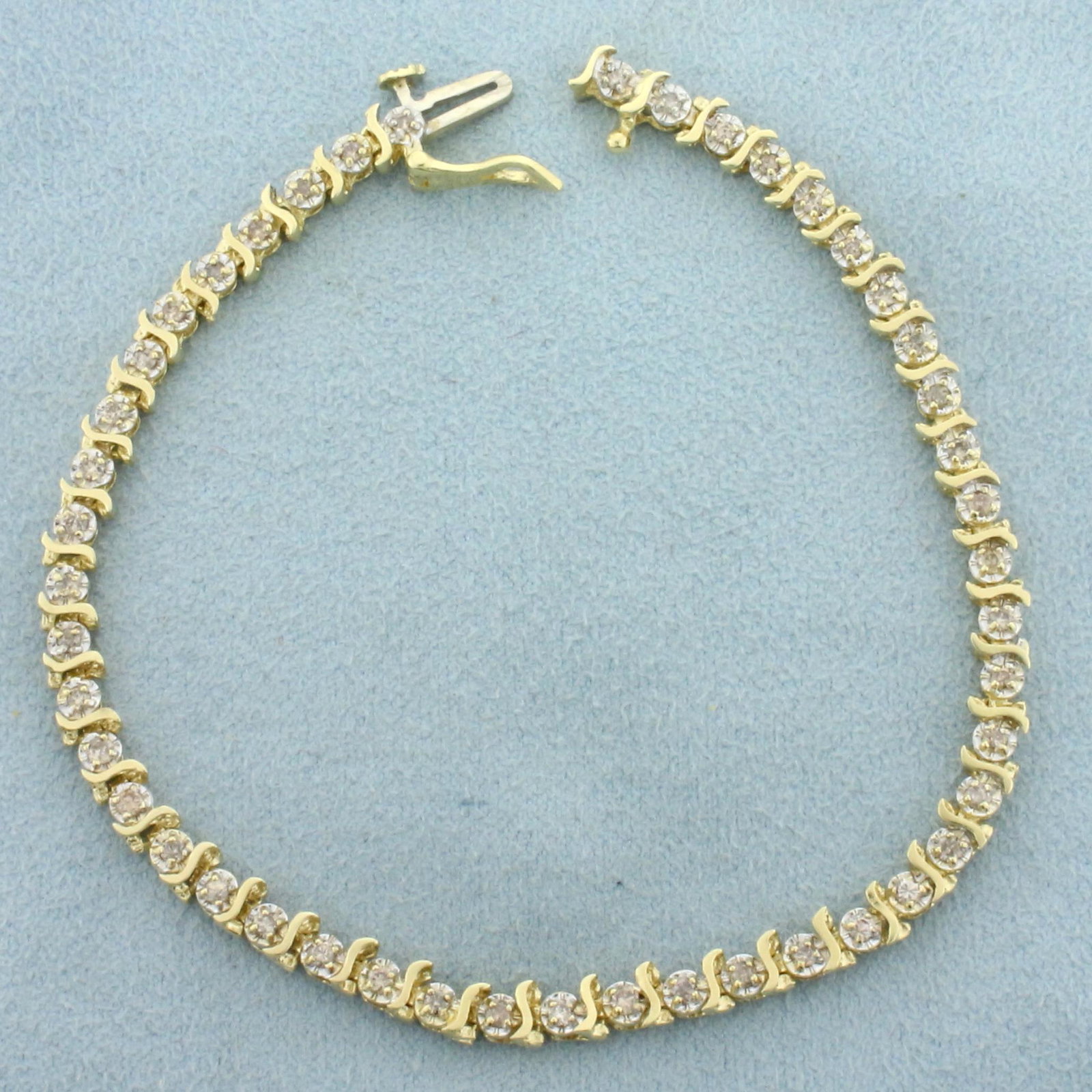 Diamond Tennis Bracelet in 14K Yellow and White Gold: In 14K Yellow and White Gold. Contains forty-six Diamonds, 1/2ct TW, L color/I clarity. With a safety clasp. 7 1/4 inches long. 4.2mm wide. 7.4g