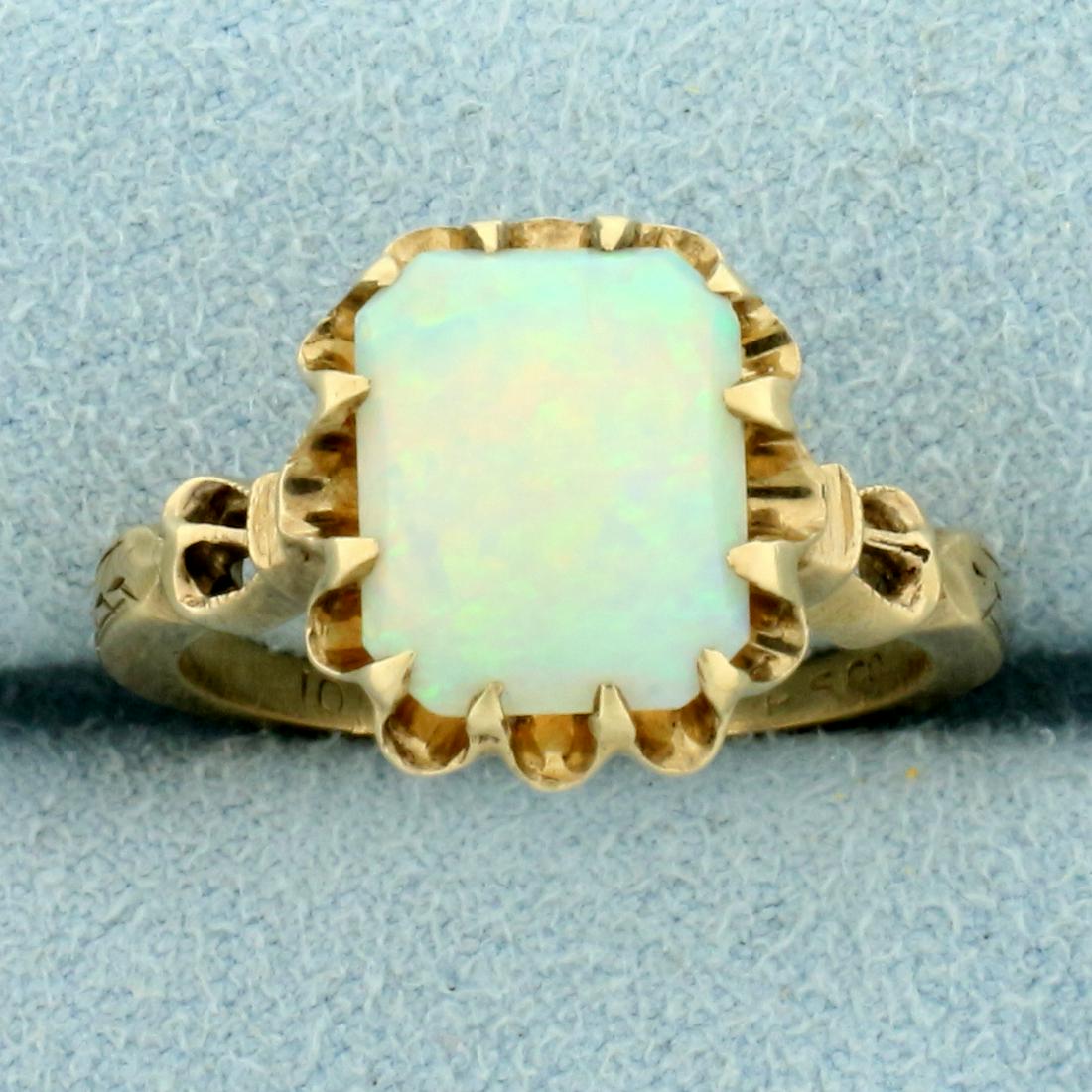 Vintage Opal Solitaire Ring in 10K Yellow Gold: In 10K Yellow Gold. Contains one high quality natural 9 x 8mm Opal gemstone with intense play of color with flashes of green, yellow, orange, and red. Size 6 1/2. 3.5g.