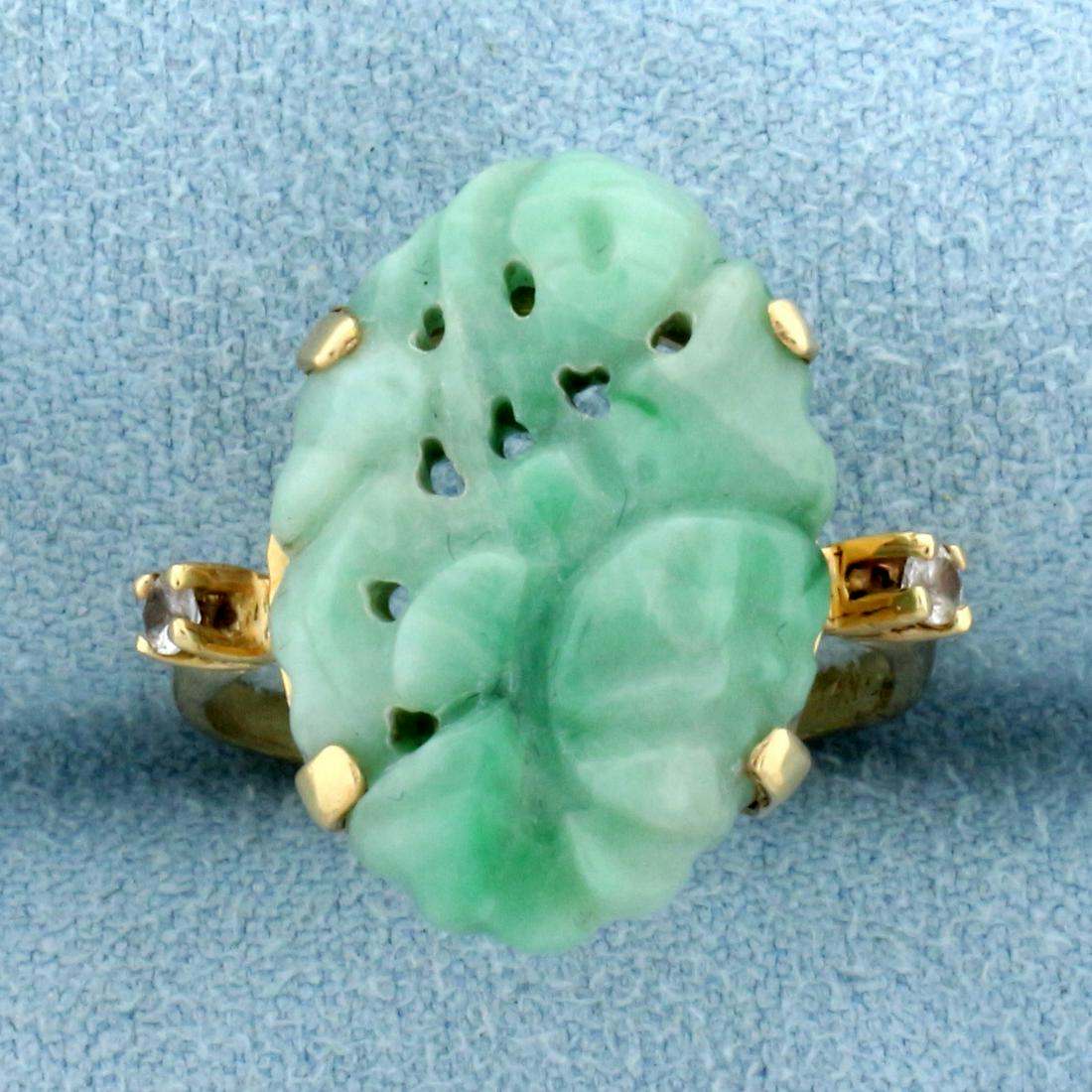 Hand Carved Jade and White Sapphire Statement Ring in: In 14K Yellow Gold. Contains one high quality natural 20 x 14mm hand carved Jade gemstone with uniform green color . Also contains two high quality .04ct White Sapphire gemstones with excellent clarit