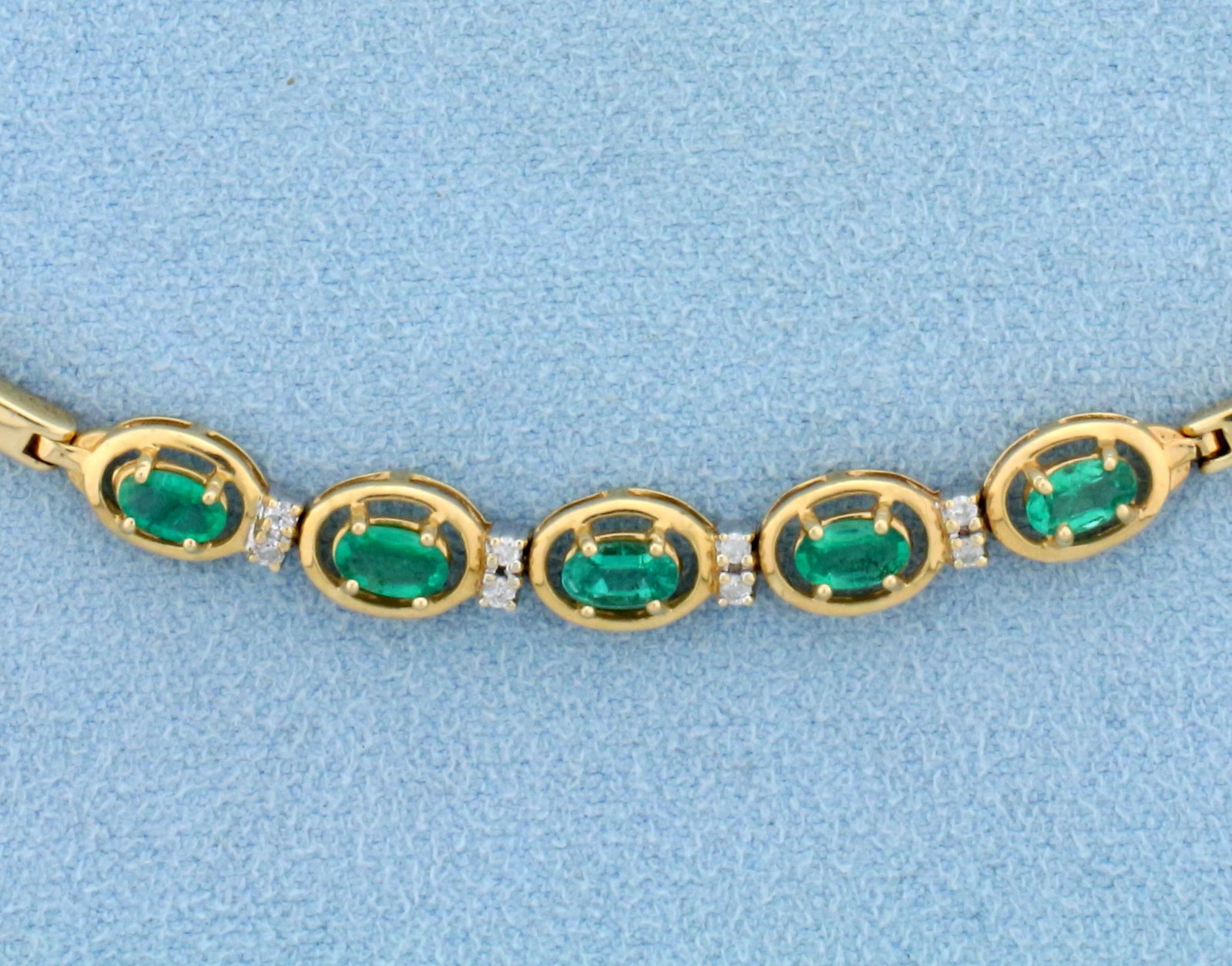 Natural Emerald and Diamond Bracelet in 14K Yellow Gold: In 14K Yellow Gold. Contains five high quality natural 5 x 3mm 1/2ct Emerald gemstones with intense bright green color and excellent clarity. Also contains eight high quality 1/2pt Diamonds. 7 1/2 inc