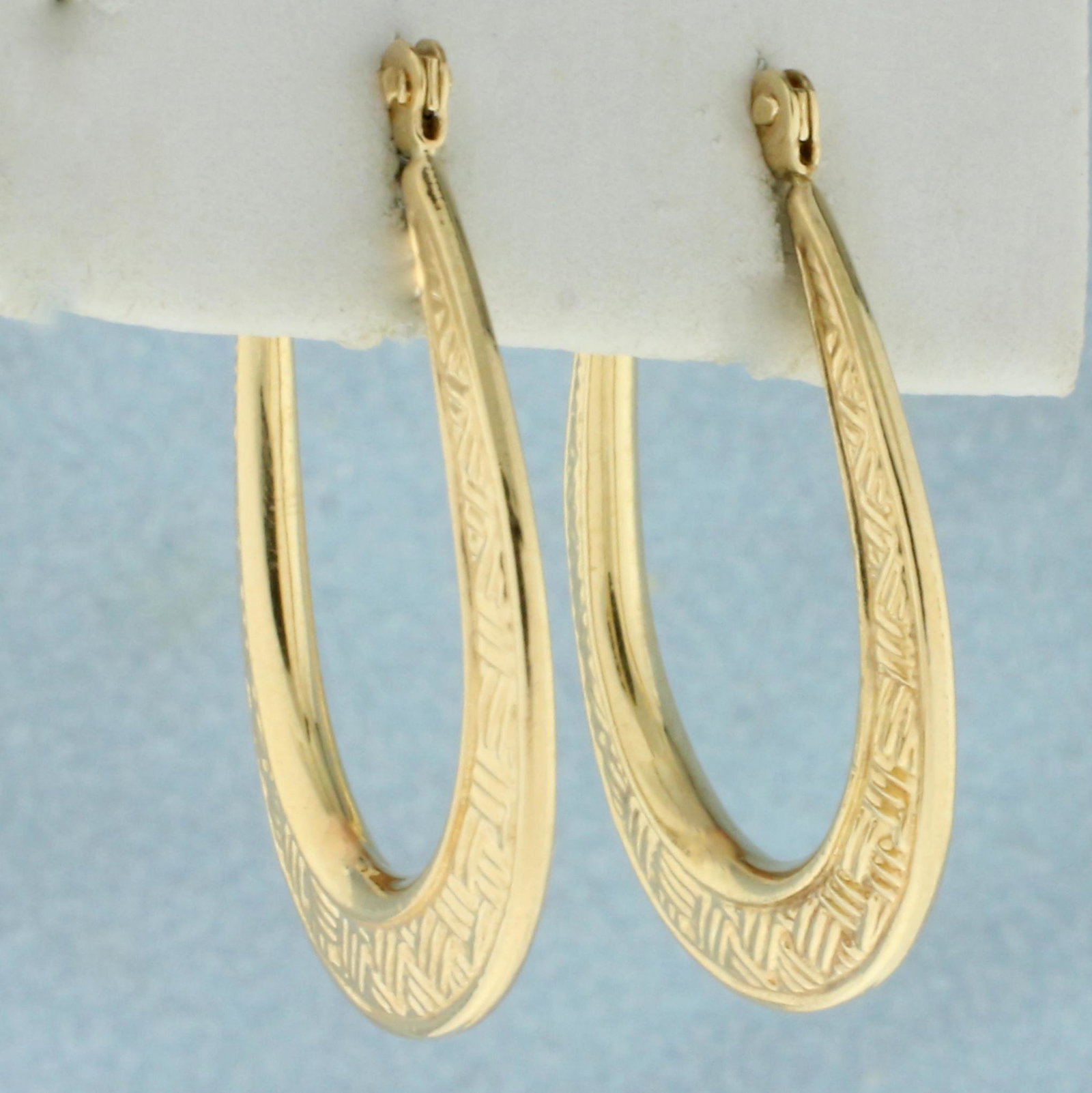 Elongated Hoop Earrings in 10K Yellow Gold: In 10K Yellow Gold. 1 inch long. 1.1g.