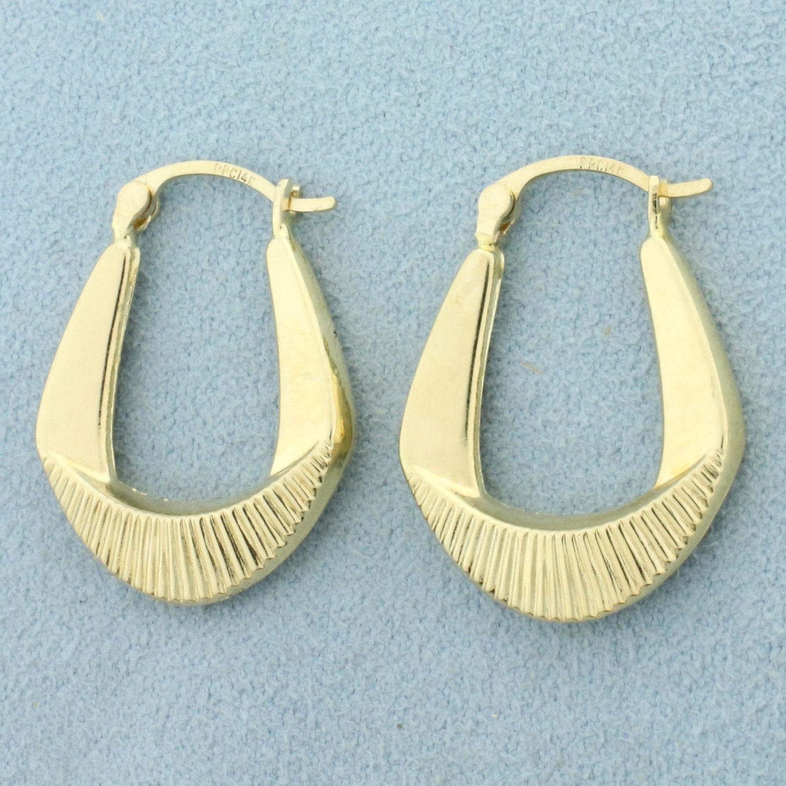 Designer Hoop Earrings in 14K Yellow Gold: In 14K Yellow Gold. 1 inch long, 3.0mm wide. 1.8g.