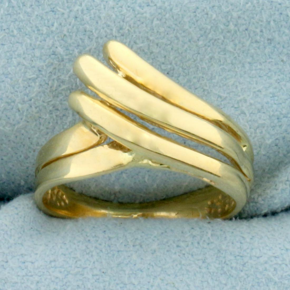 Abstract Wave Design Gold Ring in 10K Yellow Gold: In 10K Yellow Gold. Size 6. 2.7g.