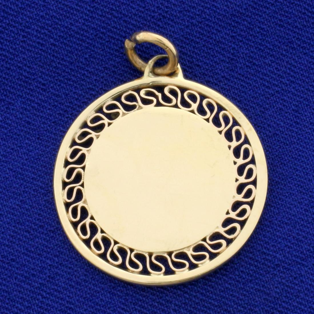 Engravable Circle Pendant in 14K Yellow Gold: In 14K Yellow Gold. 1 inch diameter, 1 1/4 inch long with jump ring. 5.4g.