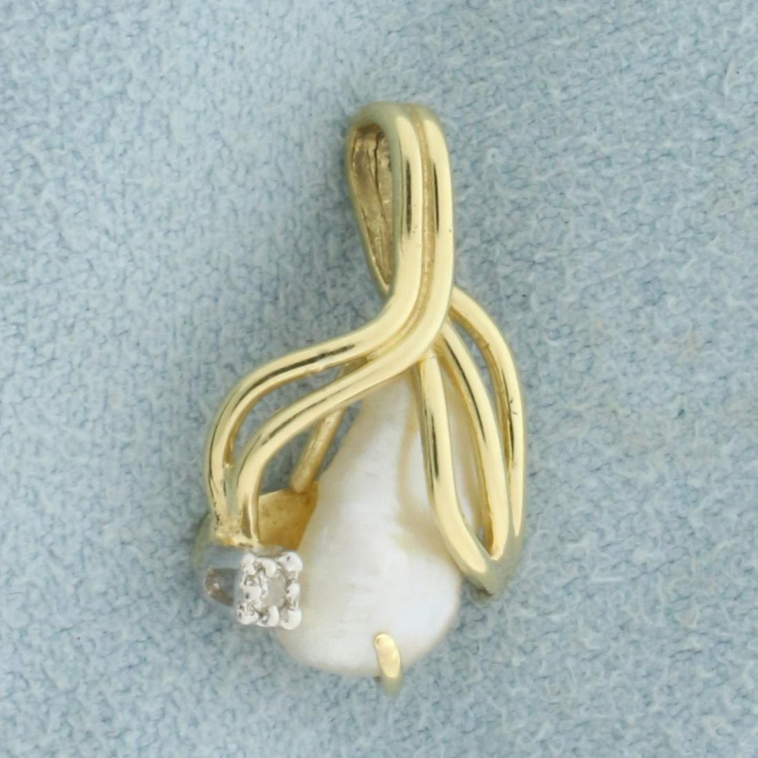 Baroque Pearl and Diamond Pendant in 14K Yellow Gold: In 14K Yellow Gold. Contains one 10.6mm Baroque Pearl with great luster and one 1/2pt Diamond. 3/4 inch long, 1/4 inch wide. 1.5g.