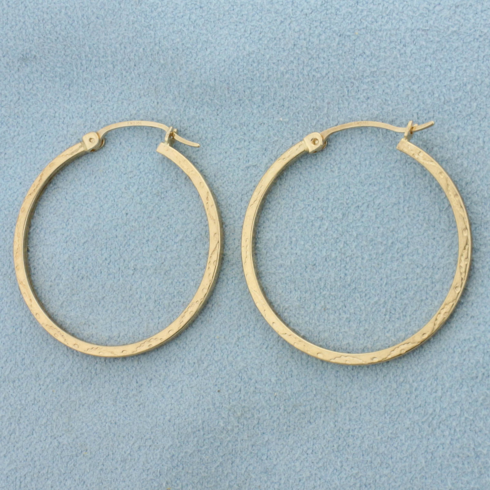 Thin Hoop Earrings in 10K Yellow Gold: In 10K Yellow Gold. 1 1/8 inches long. 1.5mm wide. 1.9g.