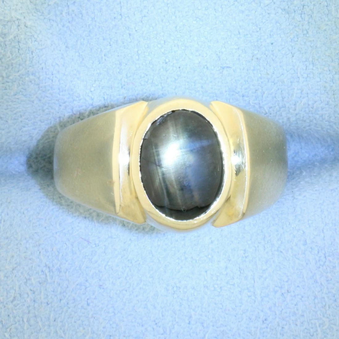 Natural 2.5ct Black Star Sapphire Solitaire Ring in 14K: In 14K Yellow Gold. Contains one high quality natural 10x7mm oval cut Grey Star Sapphire gemstone with obvious star under direct light. Size 7 1/2. 7.7g
